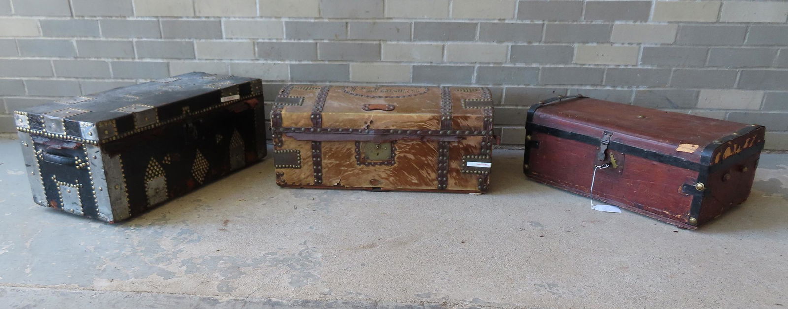 Three 19th century leather and cowhide trunks, 2 with wall papered interiors and all with tack (1 of 7)