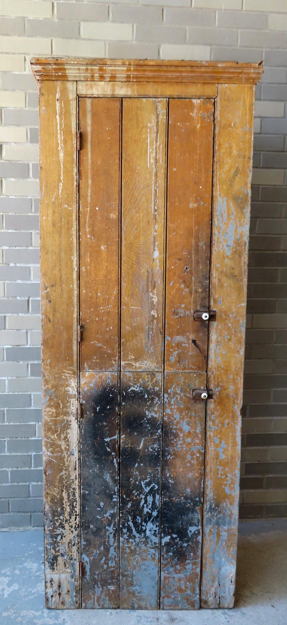 A primitive pantry cupboard in layers of old paint having 1 door over 1 door. Measures 28"W x 14 (1 of 8)