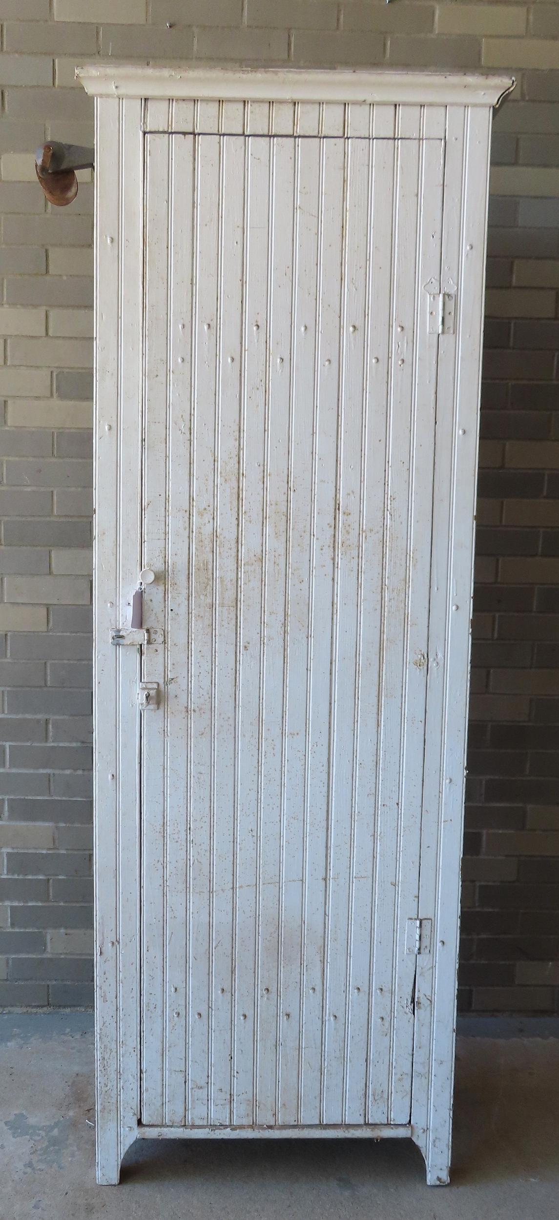 A wainscot single door kitchen cupboard on cutout base in old white paint, late 19th to early 20th (1 of 5)