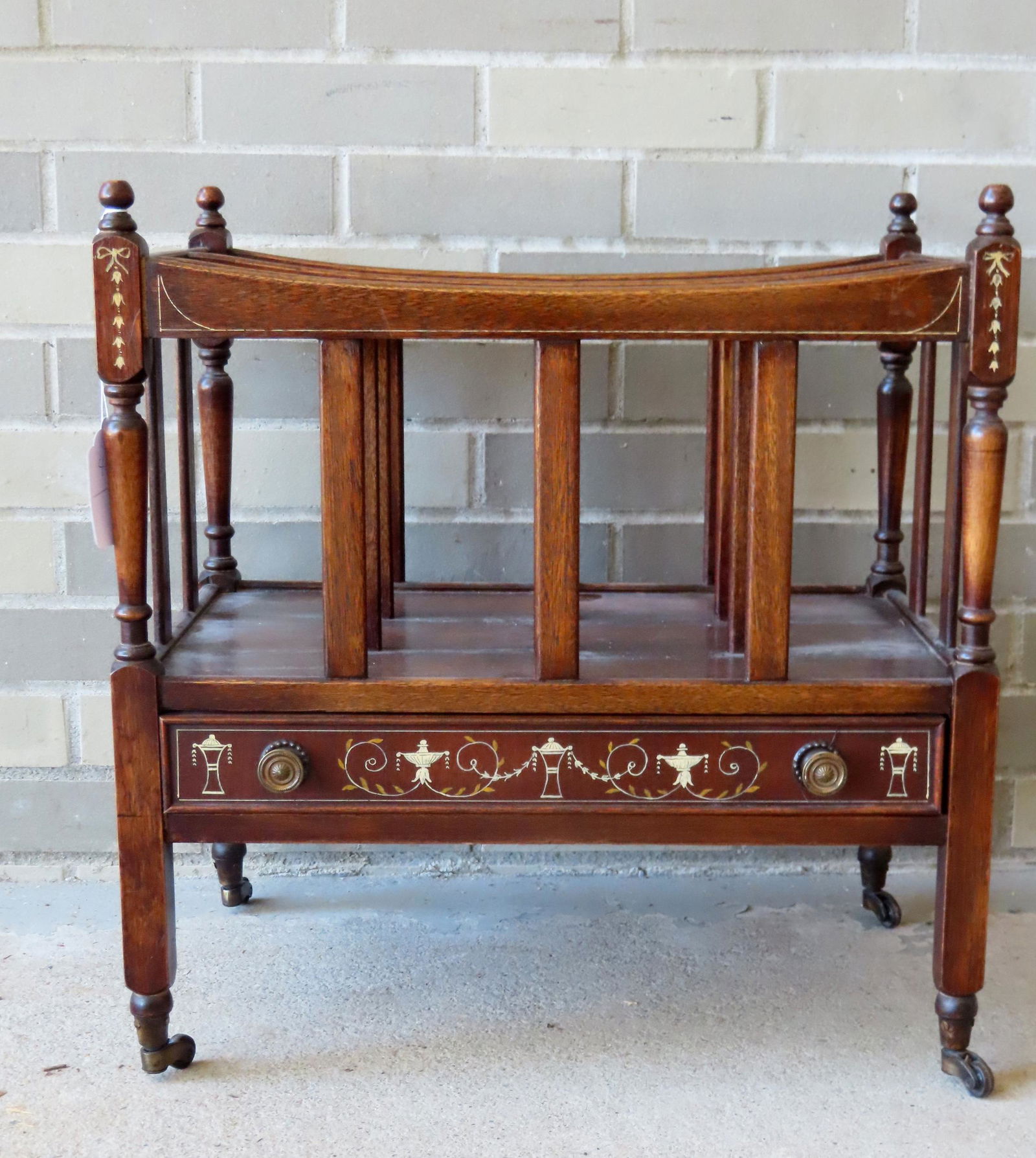 A Sheraton style magazine stand on casters with lower drawer, early 20th century, stenciled with (1 of 3)