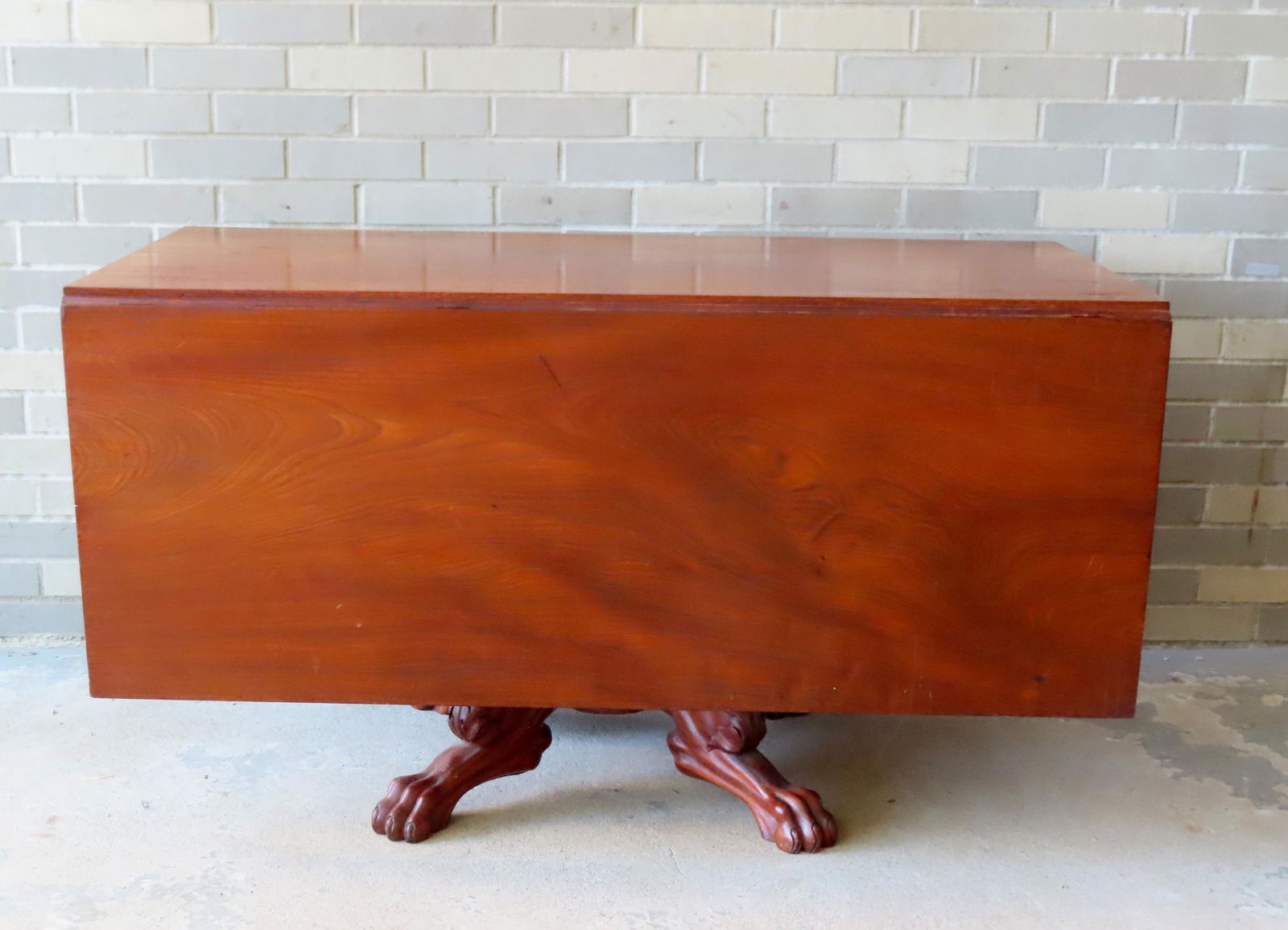 An early period Empire mahogany and walnut drop leaf dining table with a heavily carved acanthus (1 of 11)