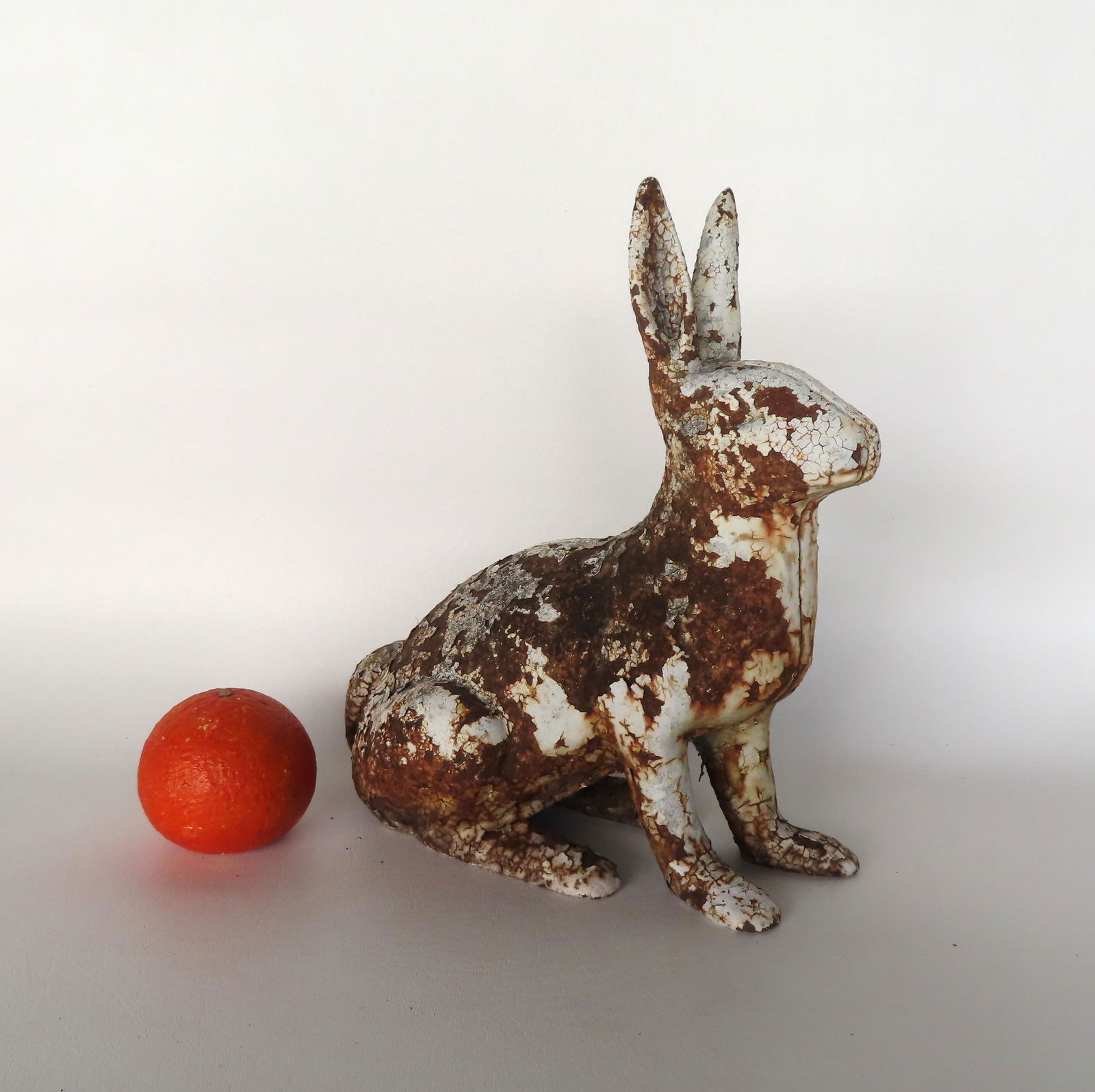 A cast iron rabbit door stop. It was found outside in a garden so layers of old white paint are (1 of 5)
