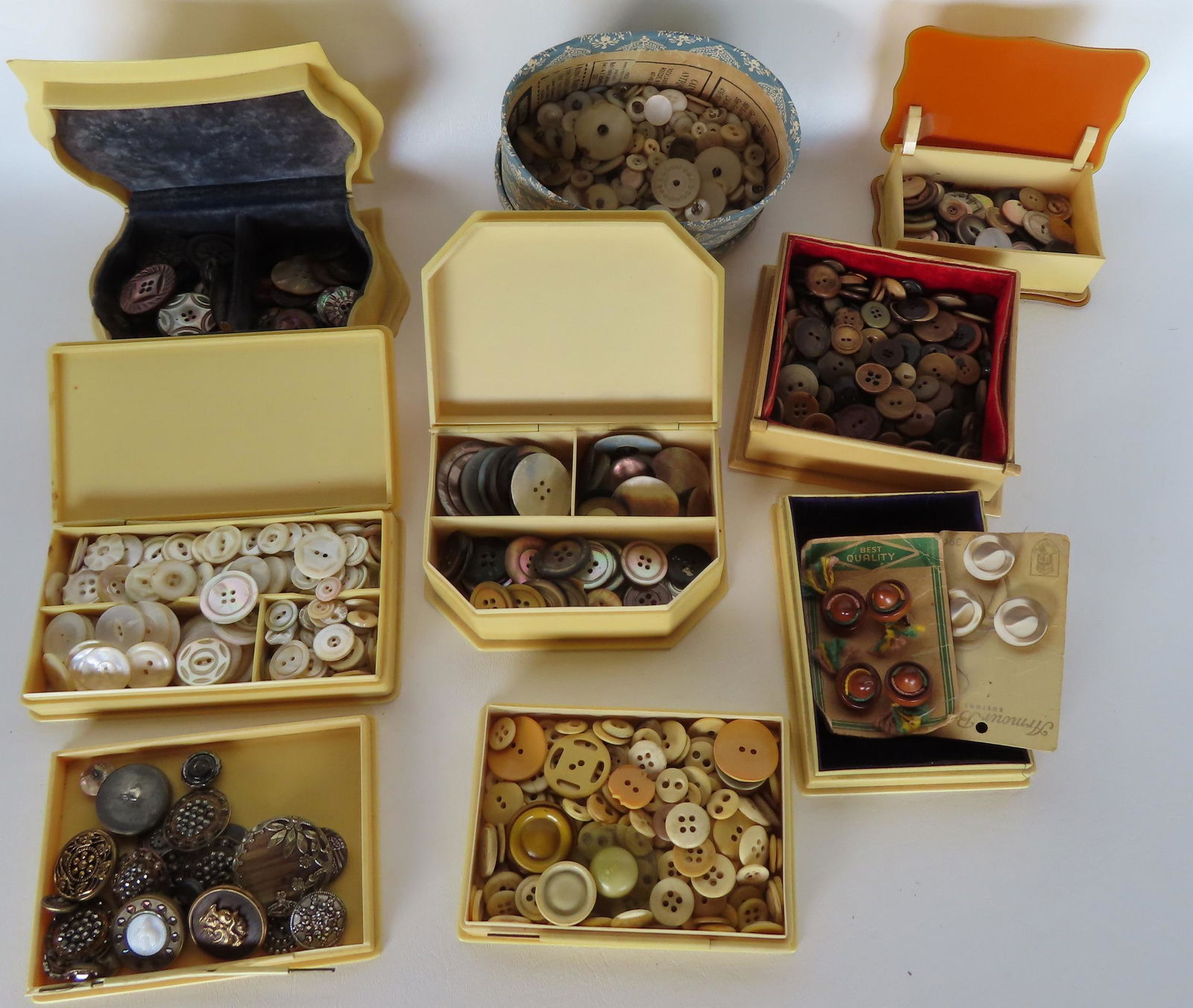 A large grouping of buttons, some in celluloid boxes. See photos for details. (1 of 7)