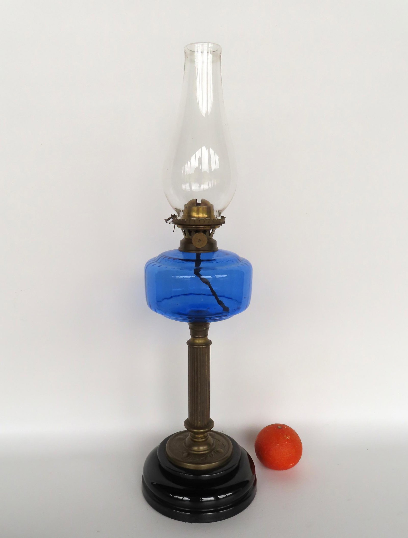 Large oil lamp with deep blue font mounted above reeded brass column attached to onyx glass stepped: Large oil lamp with deep blue font mounted above reeded brass column attached to onyx glass stepped base - note the newer plaster connecting the font to the reeded column - overall very good condition