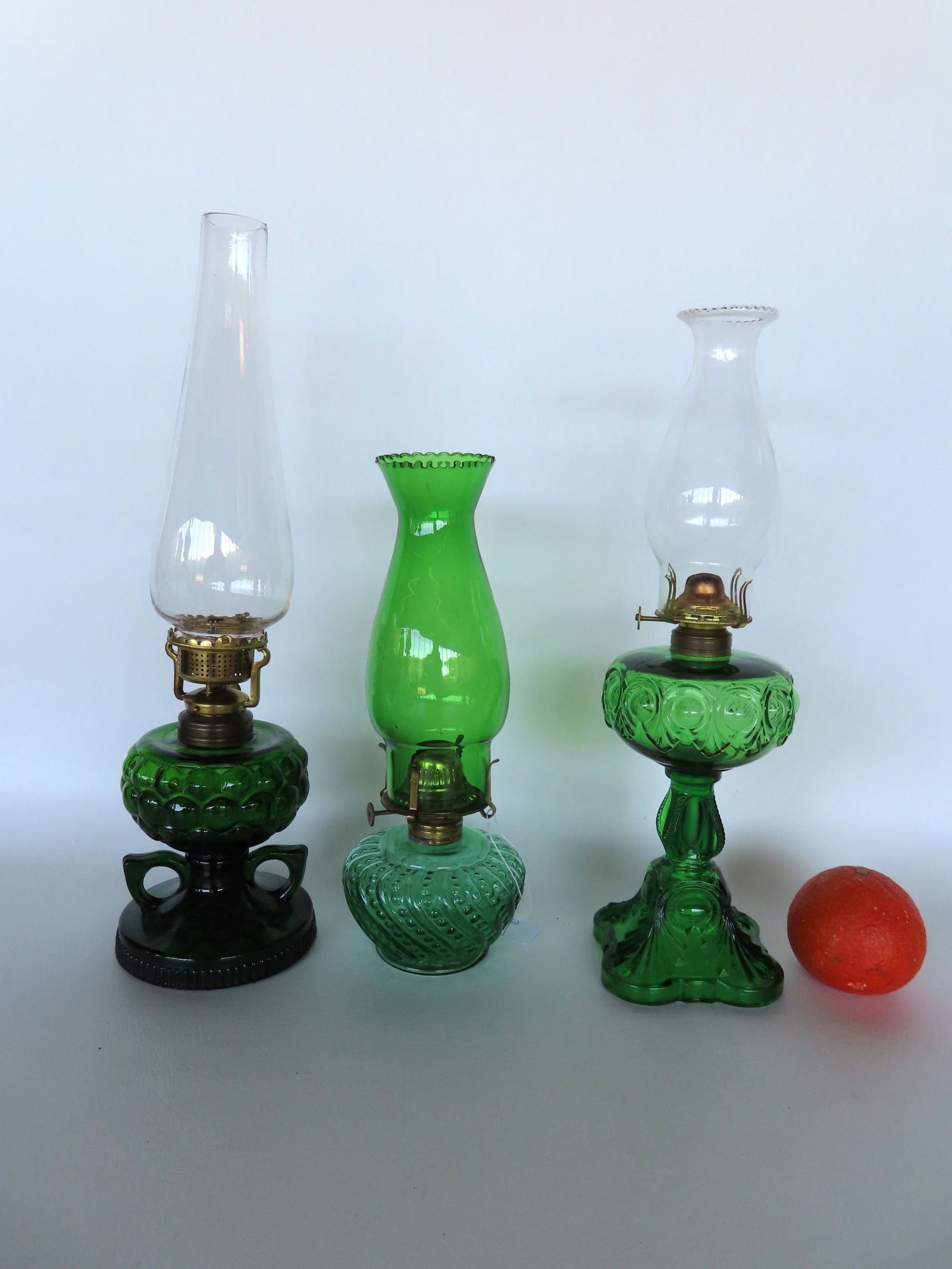 Grouping of 3 pressed glass green oil lamps including one with double fingers and one with green (1 of 4)