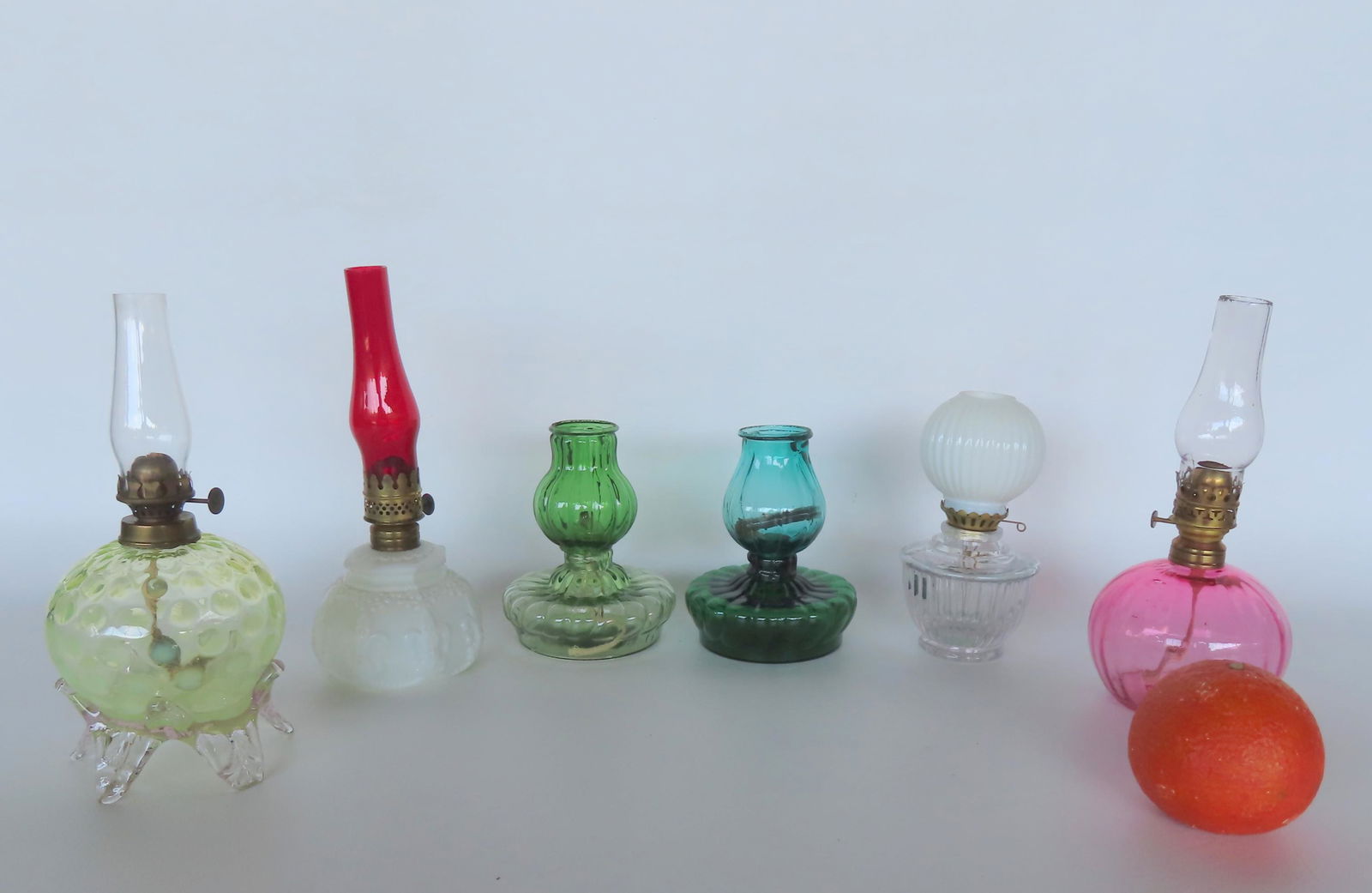 Grouping of 6 colorful miniature oil lamps, all in very good condition. The largest measures 5 1/2"H (1 of 3)