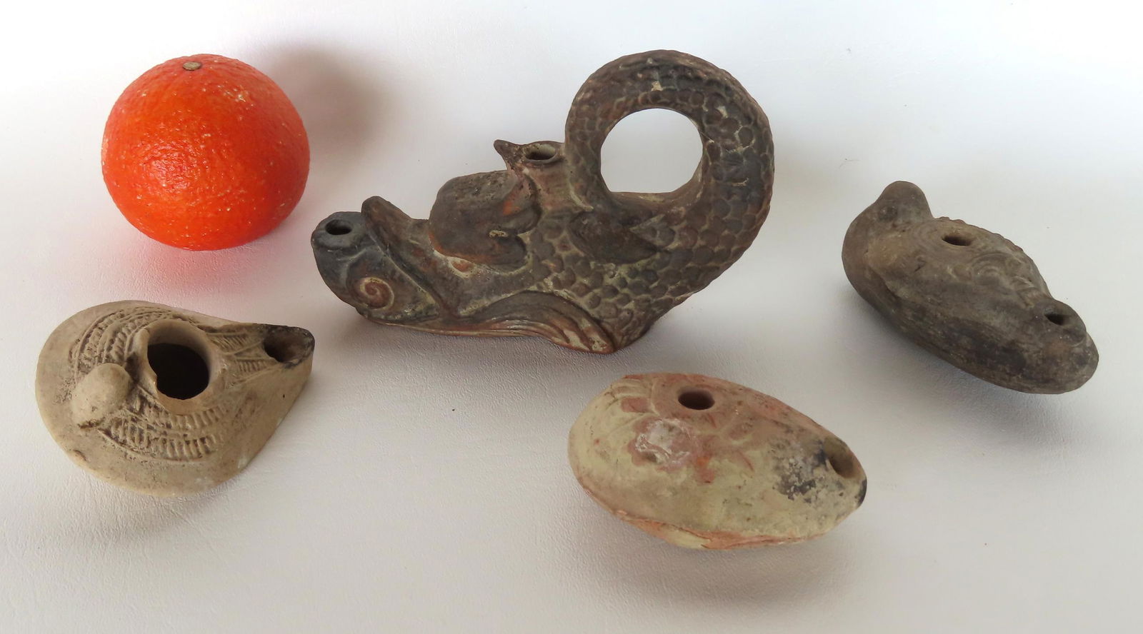 Grouping of 4 earthenware fat burning lamps, the 3 small appearing to be ancient but none have been (1 of 6)