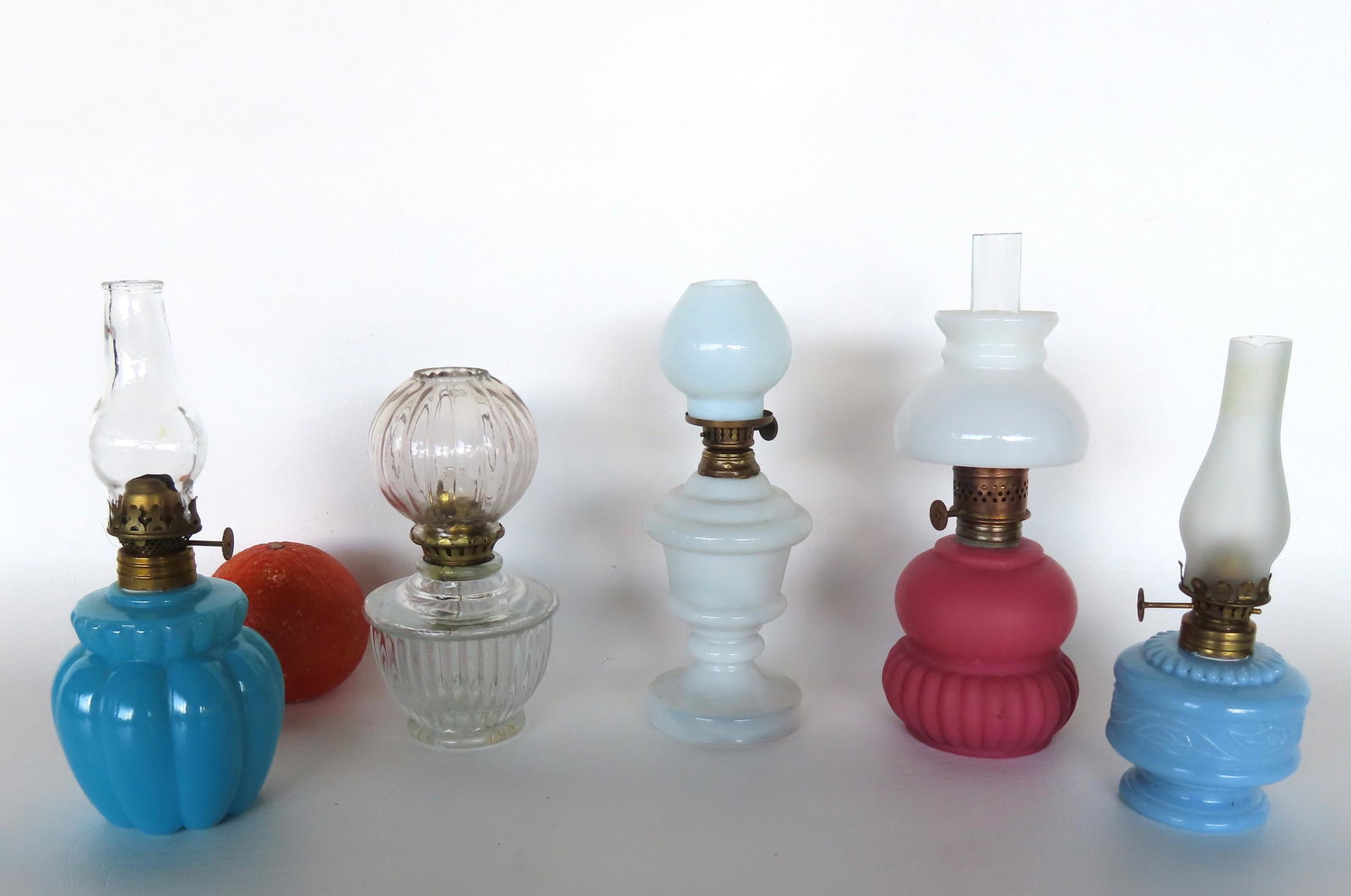 Grouping of 5 miniature oil lamps including 3 with shades. The largest with ribbed sides in opaque: Grouping of 5 miniature oil lamps including 3 with shades. The largest with ribbed sides in opaque blue measures 5"H to top of burner. All believed to be late 19th century and in very good condition. 