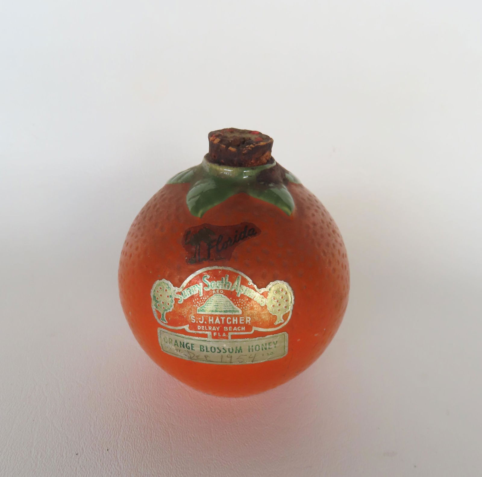 An unusual orange shaped bottle with original cork, original paint and original paper label marked (1 of 3)