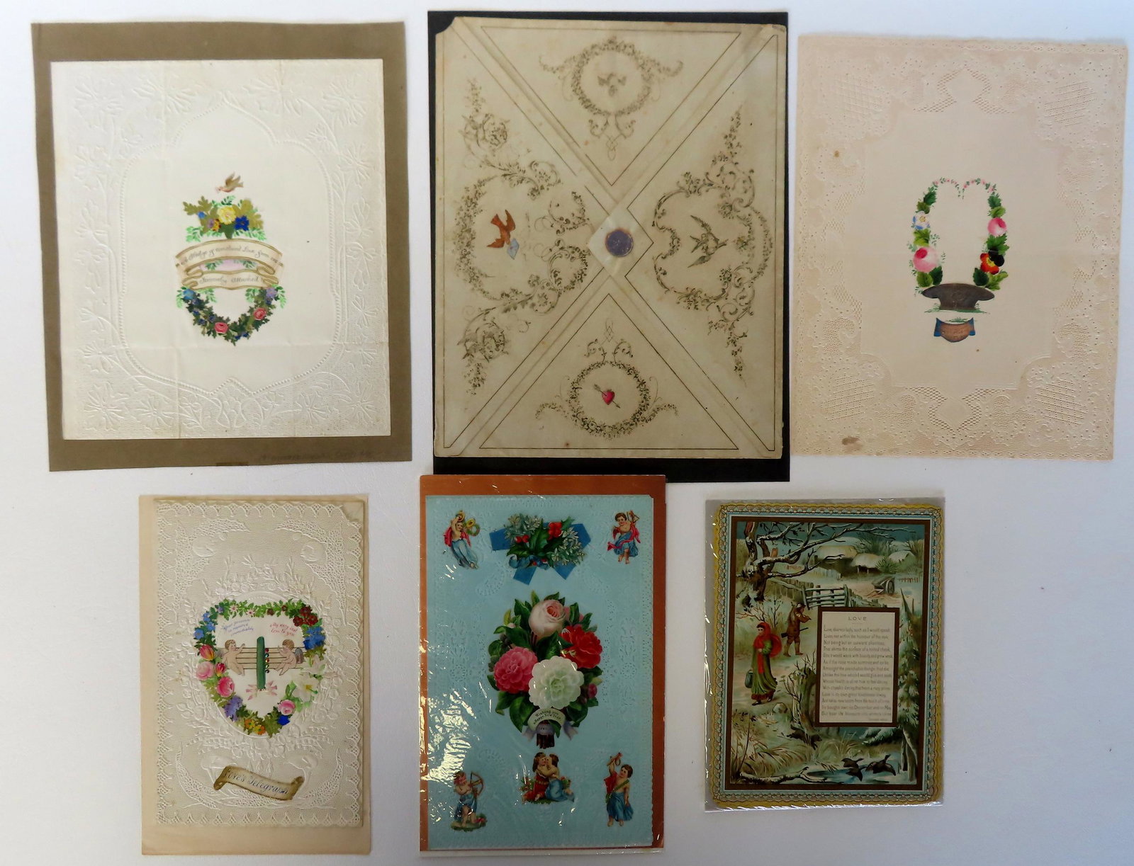 Grouping of Valentine related ephemera including: Large Valentine card with original hand colored: Grouping of Valentine related ephemera including: Large Valentine card with original hand colored lithograph envelope - the Valentine with applied die-cuts to form the image with banner that reads "A 
