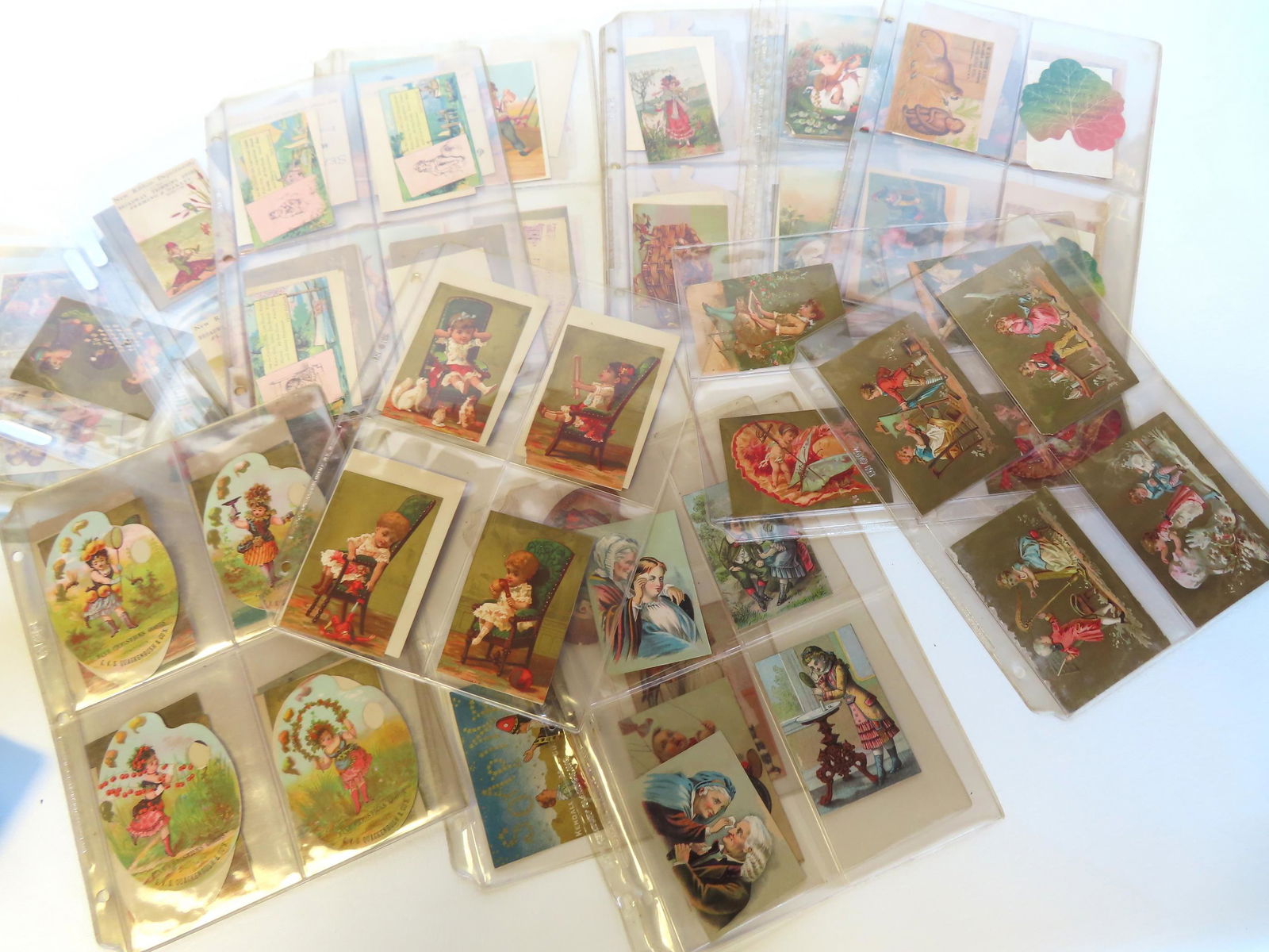 Grouping of 155 trade cards preserved within modern binder containing slotted folders (approximately (1 of 7)