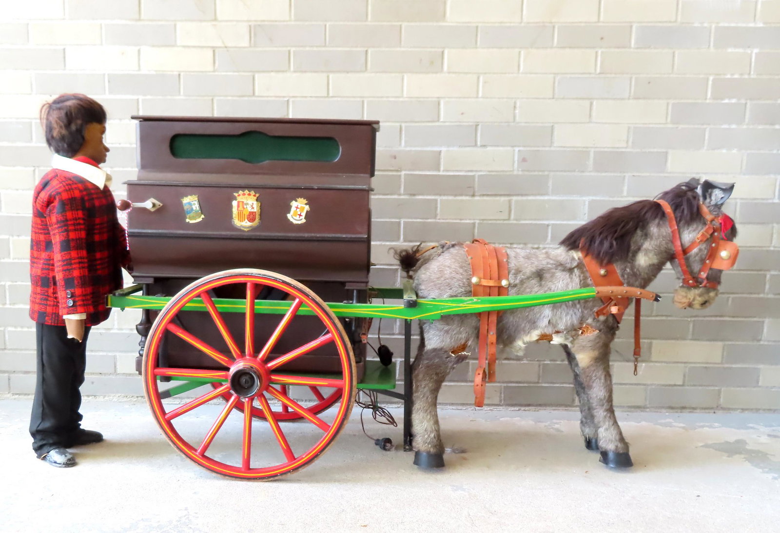 A Spanish Hurdy Gurdy, circa 1950-60.: A Spanish Hurdy Gurdy organ grinder with cart, man, donkey, and 3 boxes of extra musical cylinders. The cart with repairs to both arms, is in original paint, and otherwise good condition and the organ