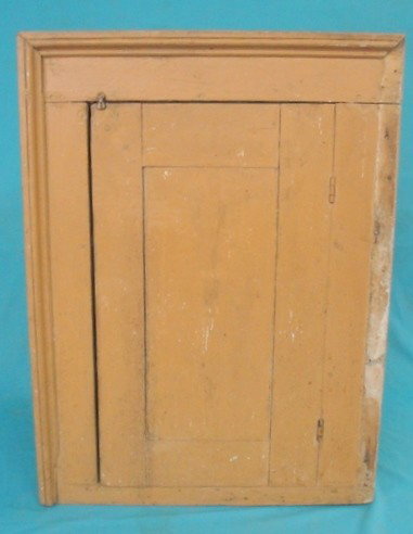 Single door built-in wall cupboard - early 19th c.: Single door built-in wall cupboard - early 19th c. - in old mustard paint - missing moulding on one side