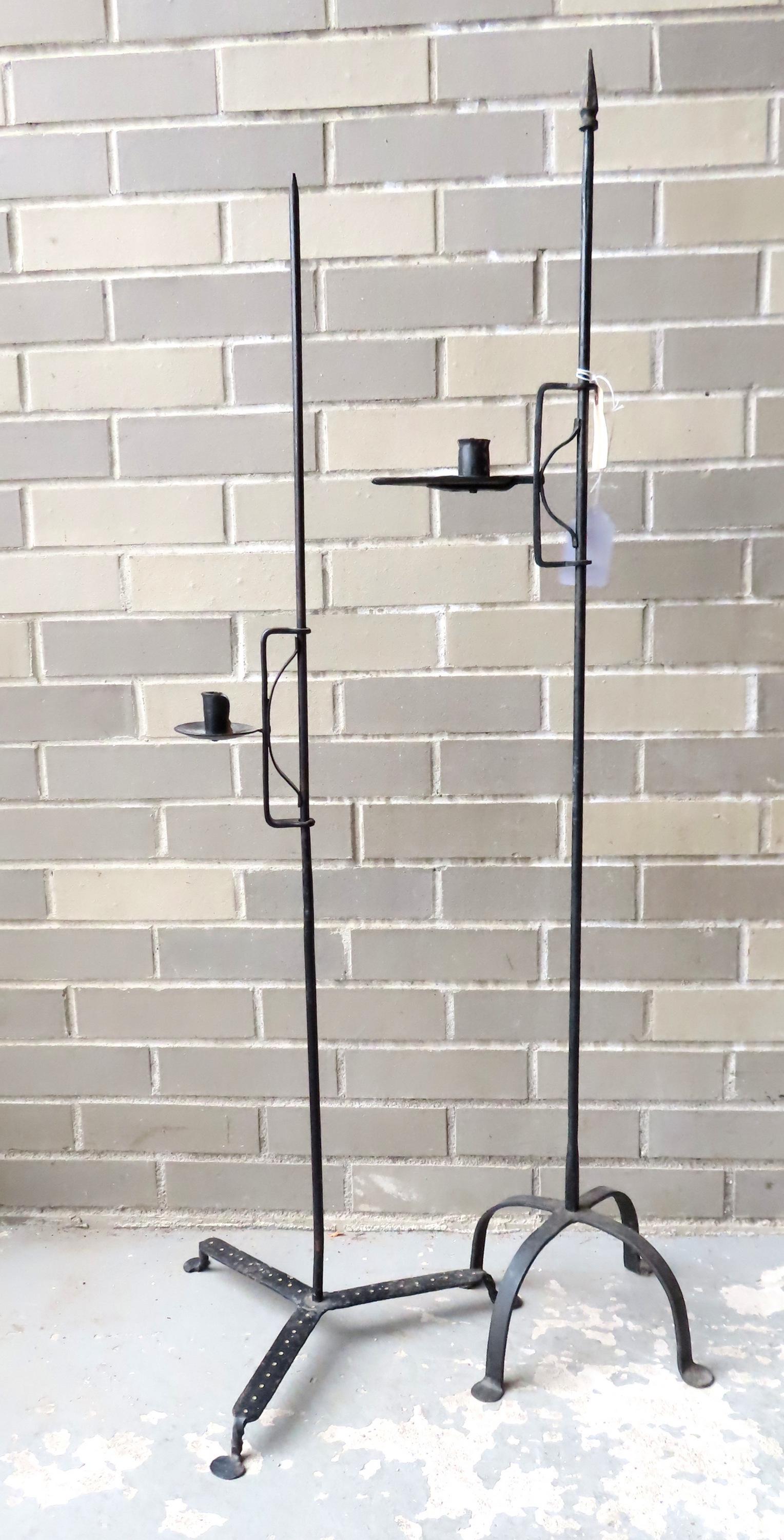 Two hand forged iron floor standing adjustable candle lighting devices, probably Queen Ann period,: Two hand forged iron floor standing adjustable candle lighting devices, probably Queen Ann period, late 18th century. Both with penny feet, and in very good working condition. Provenance: From the est
