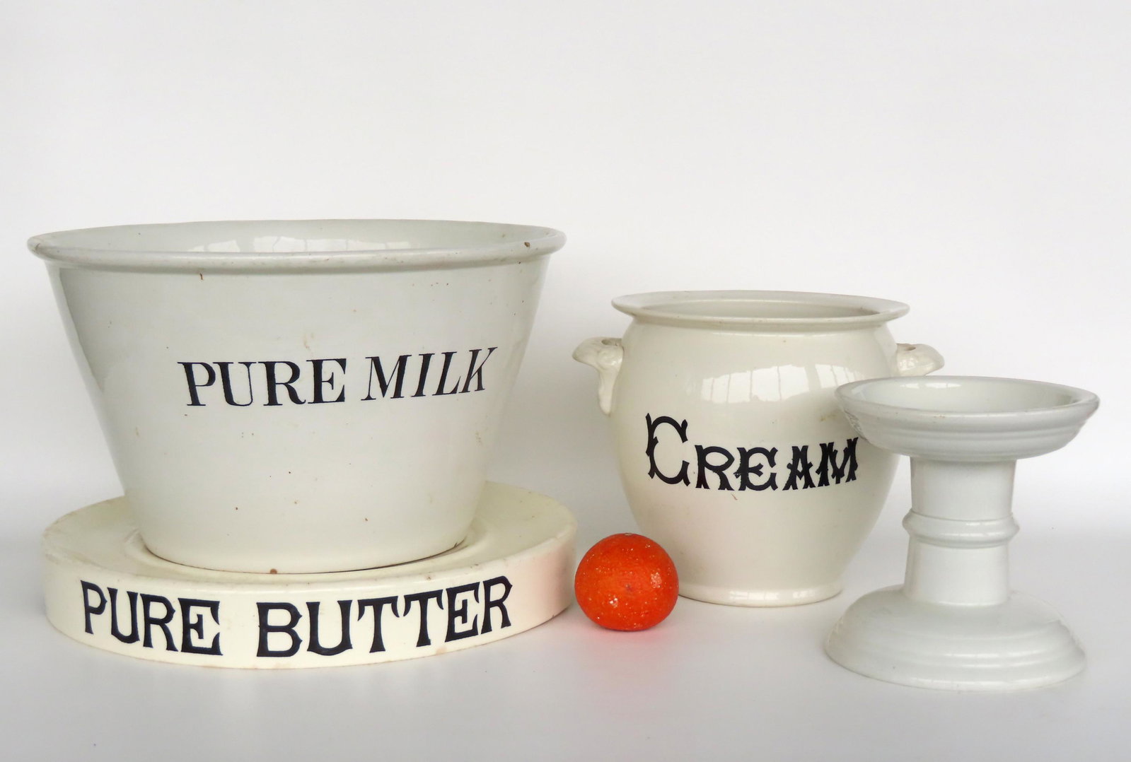 An unusual 19th century white ironstone creamery grouping.: An unusual 19th century white ironstone creamery grouping, including: A large bowl marked "PURE MILK" - 9 1/2"h X 16"W - 2 slight glazing flakes along edge of rolled rim that likely occurred in the fi