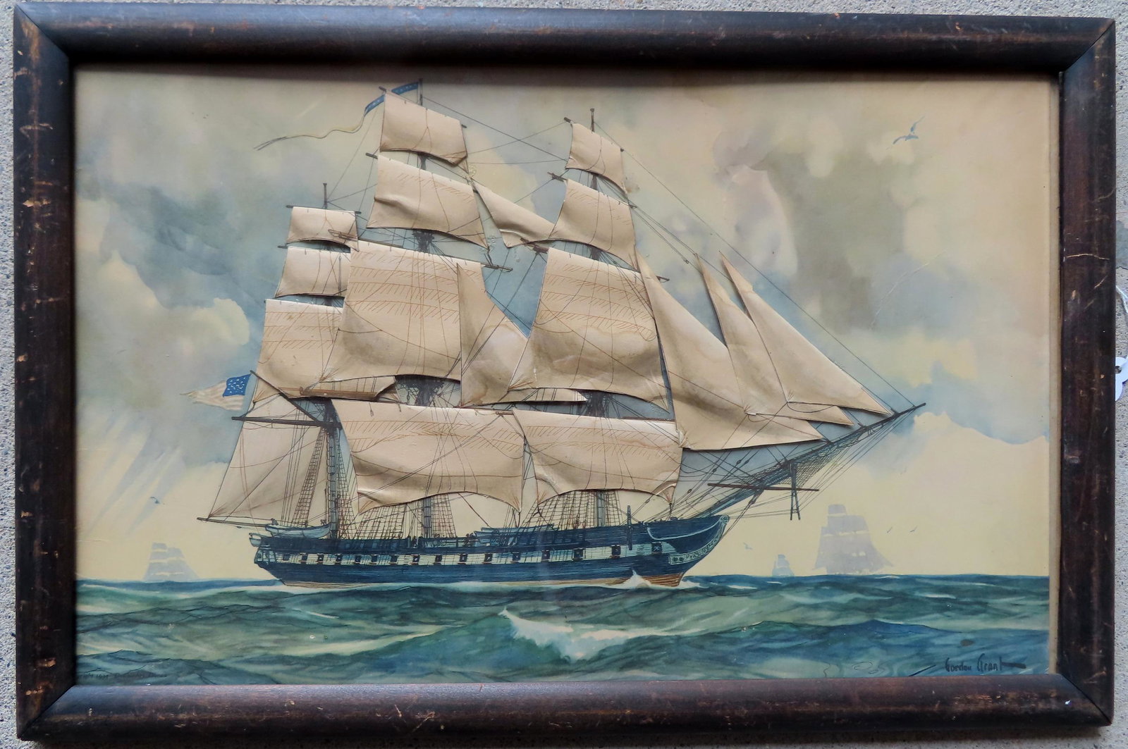 A three dimensional Gordon Grant lithograph print depicting a 3 mast sailing vessel with American: A three dimensional Gordon Grant lithograph print depicting a 3 mast sailing vessel with American flag. The ship with applied paper-cut sails to give it a 3 dimensional appearance. It is in very good 