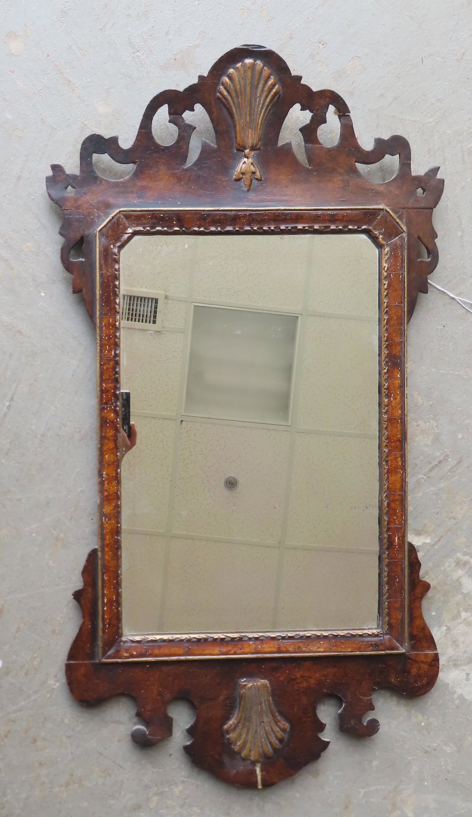 A burlwood Queen Ann wall mirror with applied carved fan shaped decorations at top and base, dated: A burlwood Queen Ann wall mirror with applied carved fan shaped decorations at top and base, dated with incised/carved date "London 1714" - also with incised/carved griffins flanking a shield. Glue re
