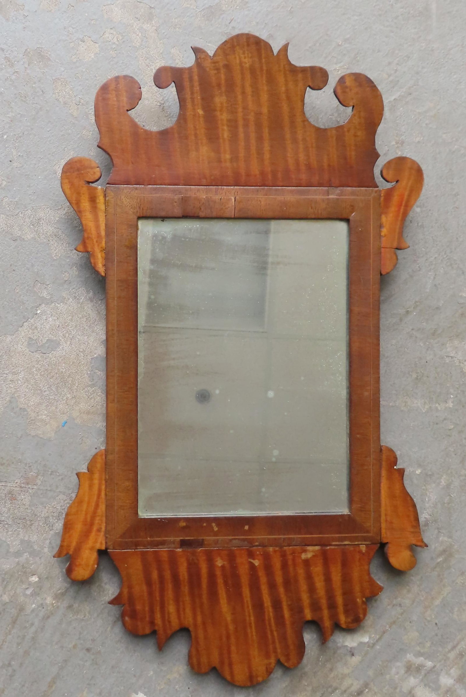 A small Chippendale style wall mirror in tiger maple and mahogany, early to mid 19th century. The: A small Chippendale style wall mirror in tiger maple and mahogany, early to mid 19th century. The looking glass appears to be original. Very good condition. Measures 12 1/4 x 21". Provenance: From the