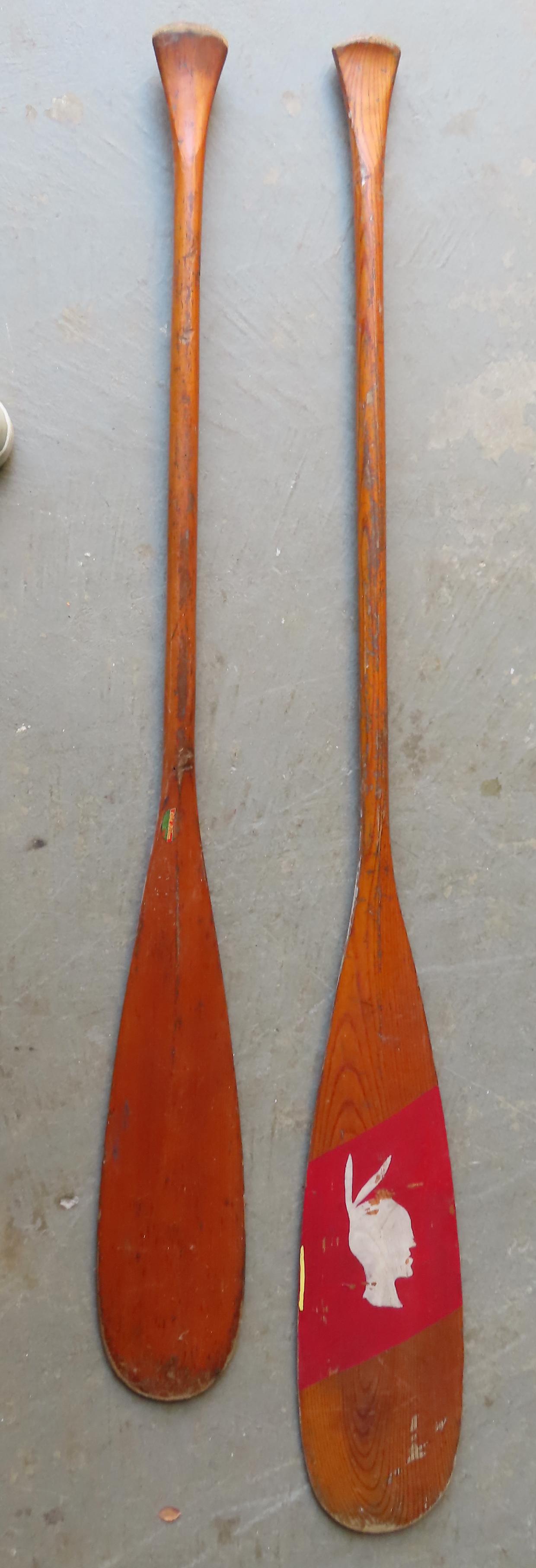 Two vintage canoe paddles, early 20th century. The first with original Old Town Canoe label - good: Two vintage canoe paddles, early 20th century. The first with original Old Town Canoe label - good condition - 57 1/4"H; the second, with hand painted figure of an Indian brave on the paddle's blade -