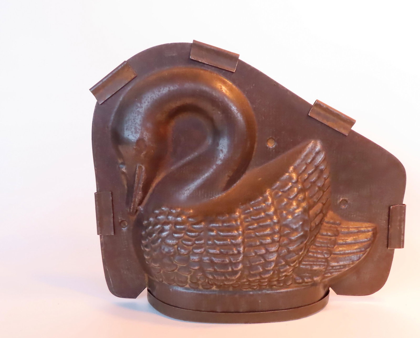 A large tin chocolate mold in the form of a swan - 10 1/2" W x 8 3/4"H. Very good condition, late: A large tin chocolate mold in the form of a swan - 10 1/2" W x 8 3/4"H. Very good condition, late 19th to early 20th century. Provenance: From the estate of Barbara Becker, High Falls NY. This lot is 