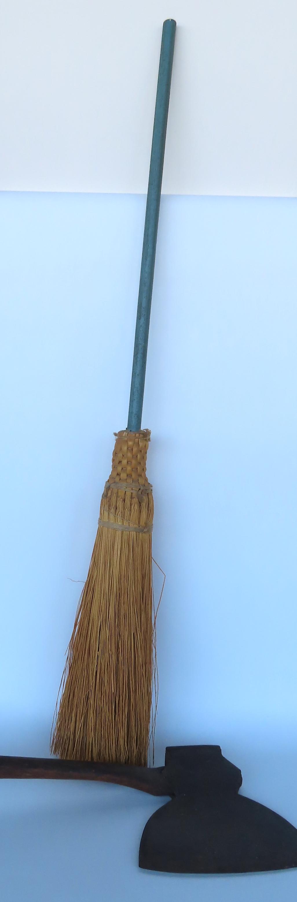 Two country items including: Shaker broom with handle in original light green paint - 46"H; together: Two country items including: Shaker broom with handle in original light green paint - 46"H; together with a broad ax signed "Collins & Co. / Hartford / Cast Steel Warranted" - very good condition.