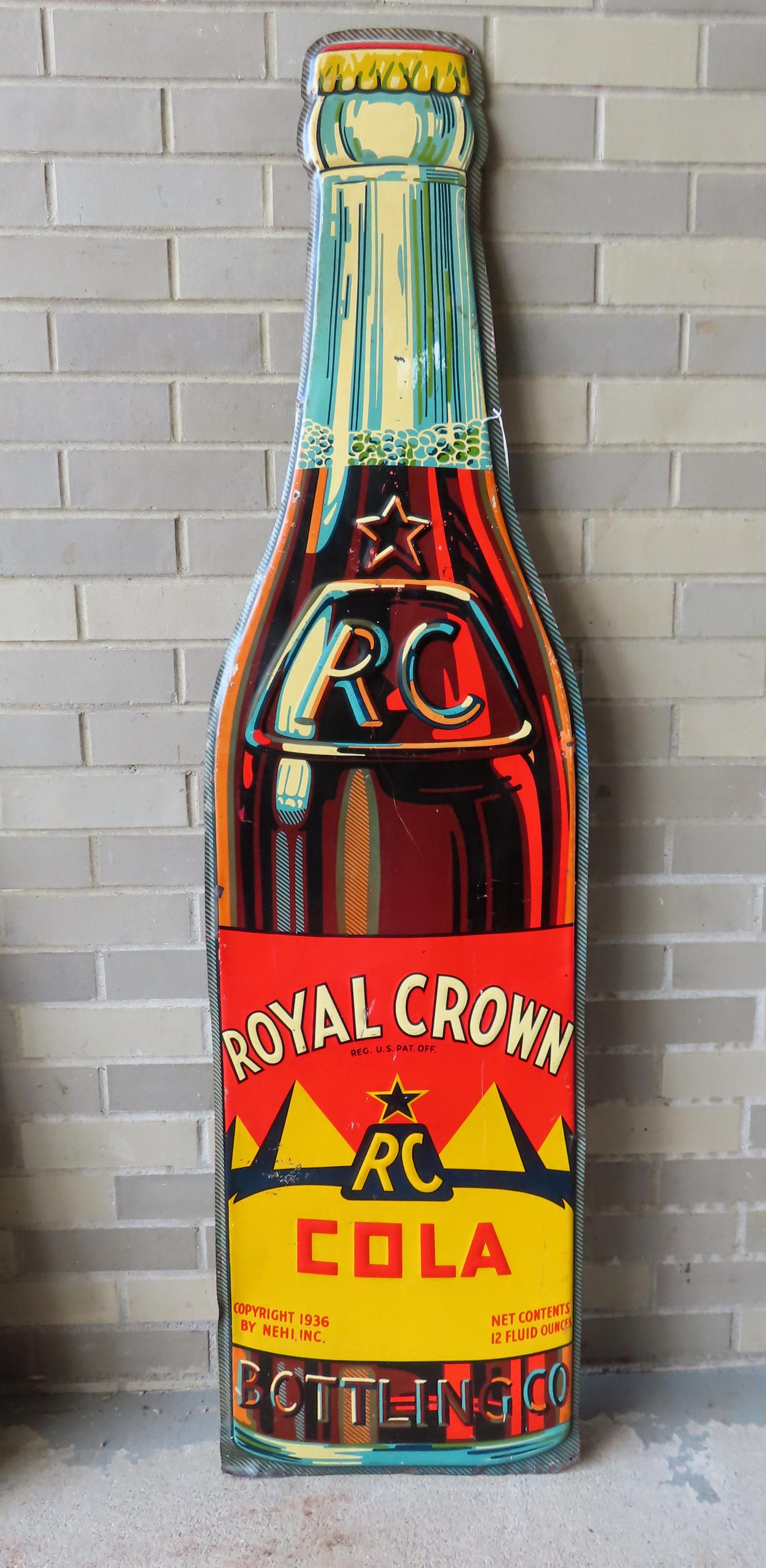 A large lithograph tin sign "ROYAL CROWN COLA", in the form of a bottle - 59"H x 15 1/2"W. Also: A large lithograph tin sign "ROYAL CROWN COLA", in the form of a bottle - 59"H x 15 1/2"W. Also marked "Copyright 1936 By Nehi, Inc." - some scuff marks and minor scratches but overall very good condi