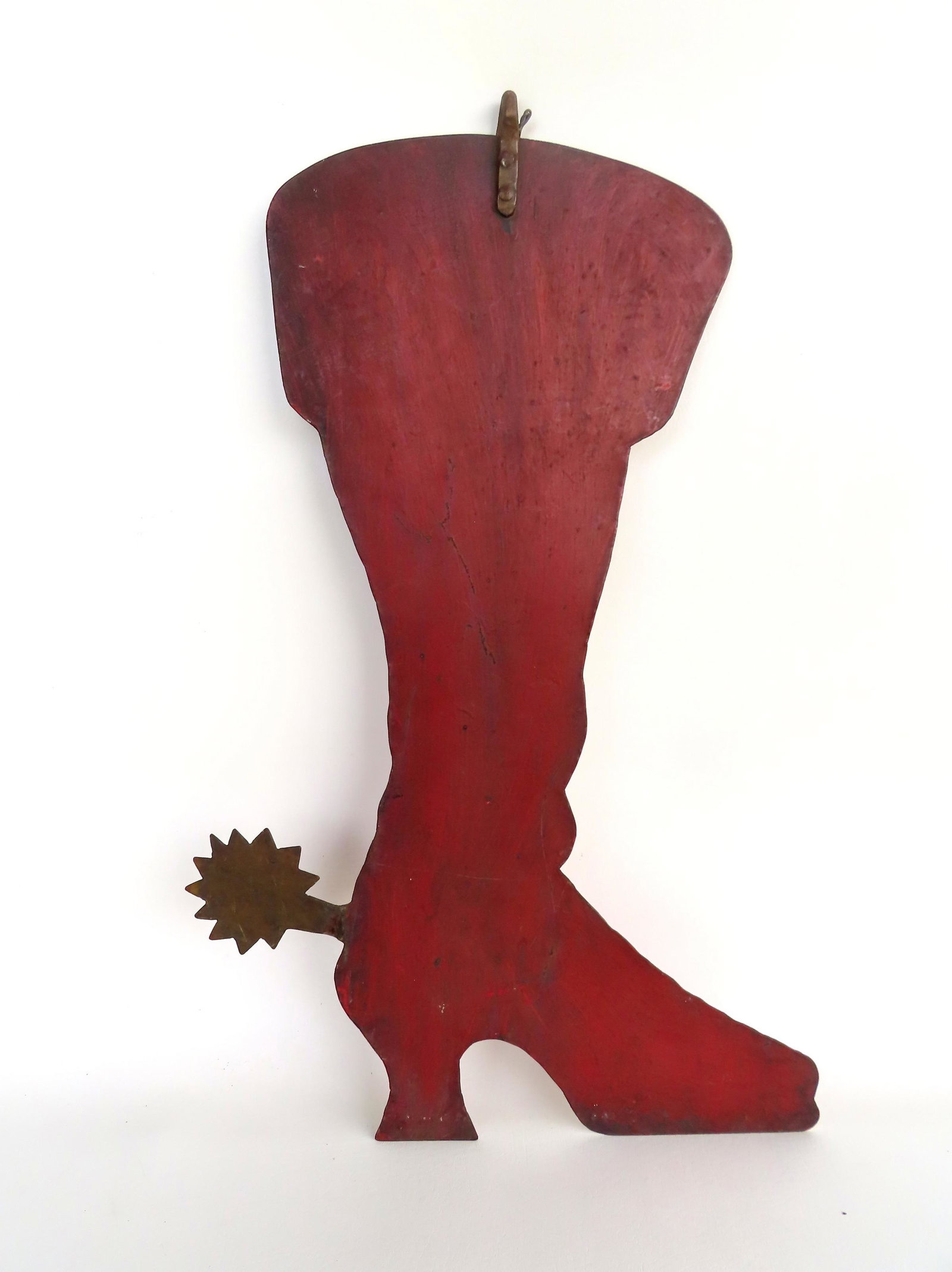 Boot maker silhouette trade sign. An unusual early sheet iron trade store sign in the shape of a: Boot maker silhouette trade sign. An unusual early sheet iron trade store sign in the shape of a boot with spur. The boot in old red paint, possibly original, and the spur in a brass colored paint tha