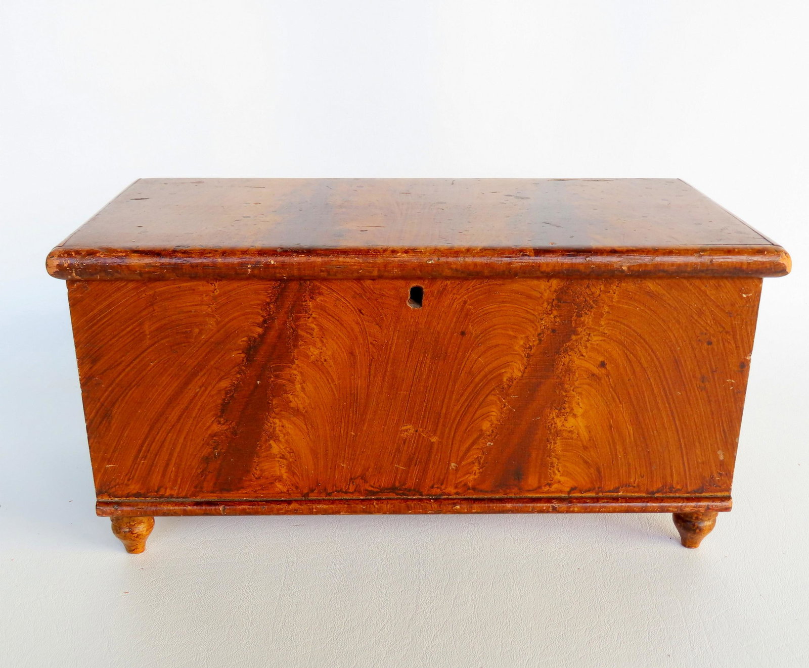 A miniature grain painted blanket box with interior till and drawer mounted on turned feet, poplar: A miniature grain painted blanket box with interior till and drawer mounted on turned feet, poplar wood construction, probably Pennsylvania circa 1850. Good condition. Measures 13 1/2"W x 6 1/2"D x 7"