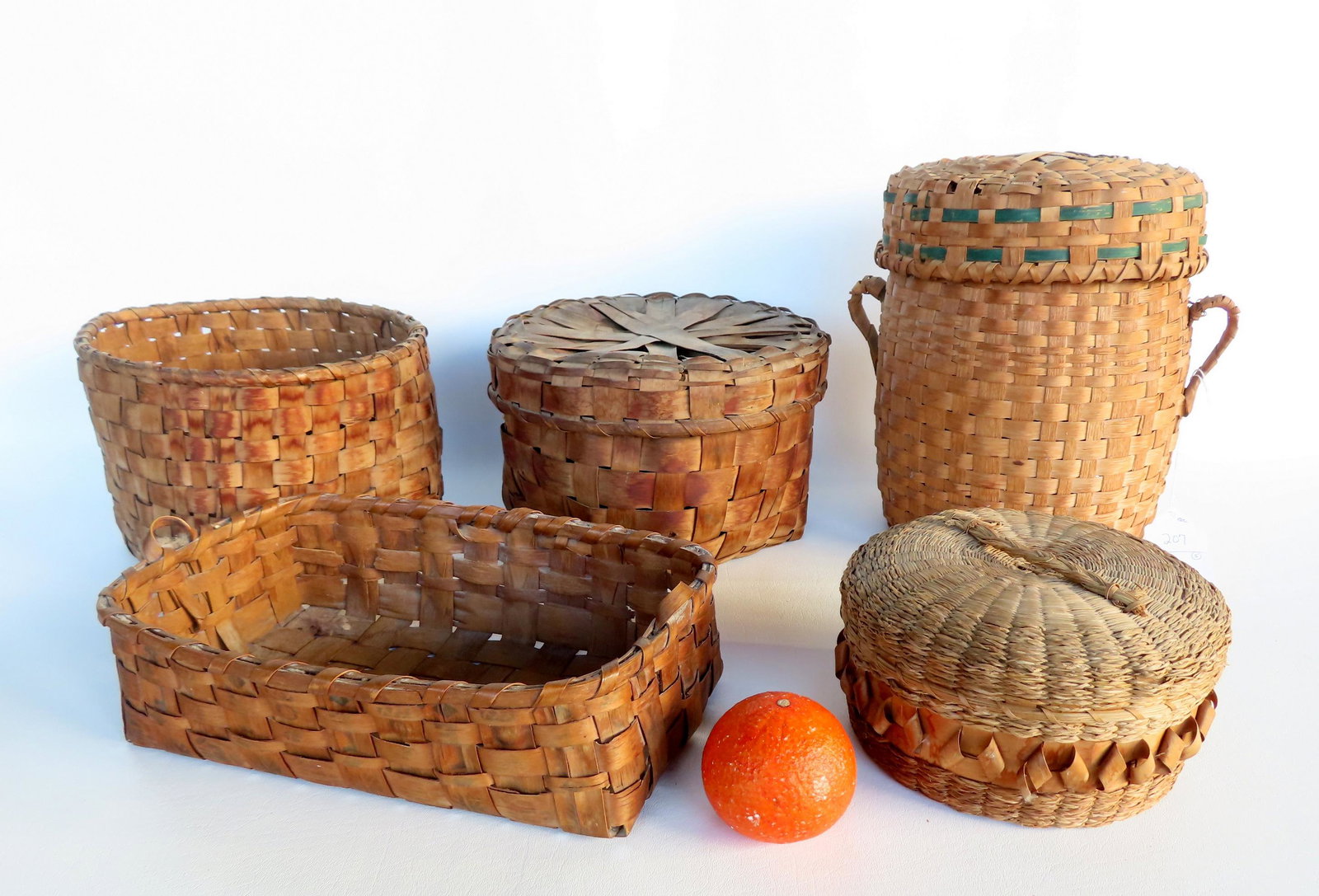 Grouping of 5 Native American baskets. One decorated with green potato stamps and having small: Grouping of 5 Native American baskets. One decorated with green potato stamps and having small U-shaped end handles - very good condition. The others with minor splint breaks are in very good conditio
