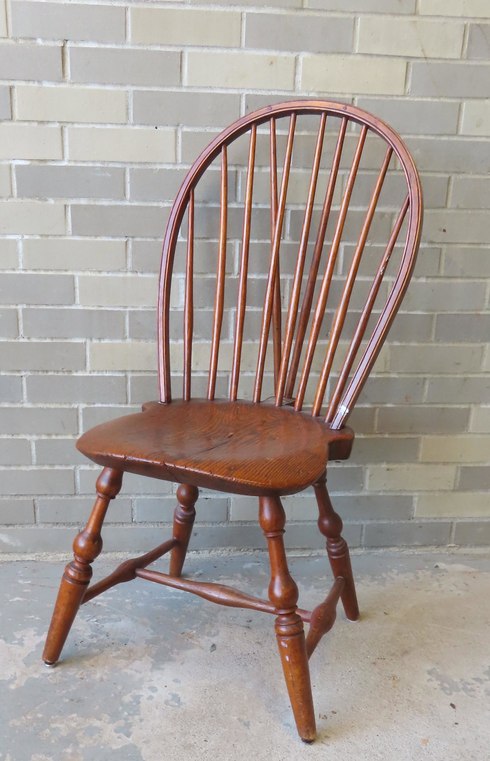 A brace-back Windsor side chair with 8 spindles on stretch base with splayed legs. Note the: A brace-back Windsor side chair with 8 spindles on stretch base with splayed legs. Note the dovetailed repair on underside of seat, otherwise very good refinished condition, late 18th century. Provena