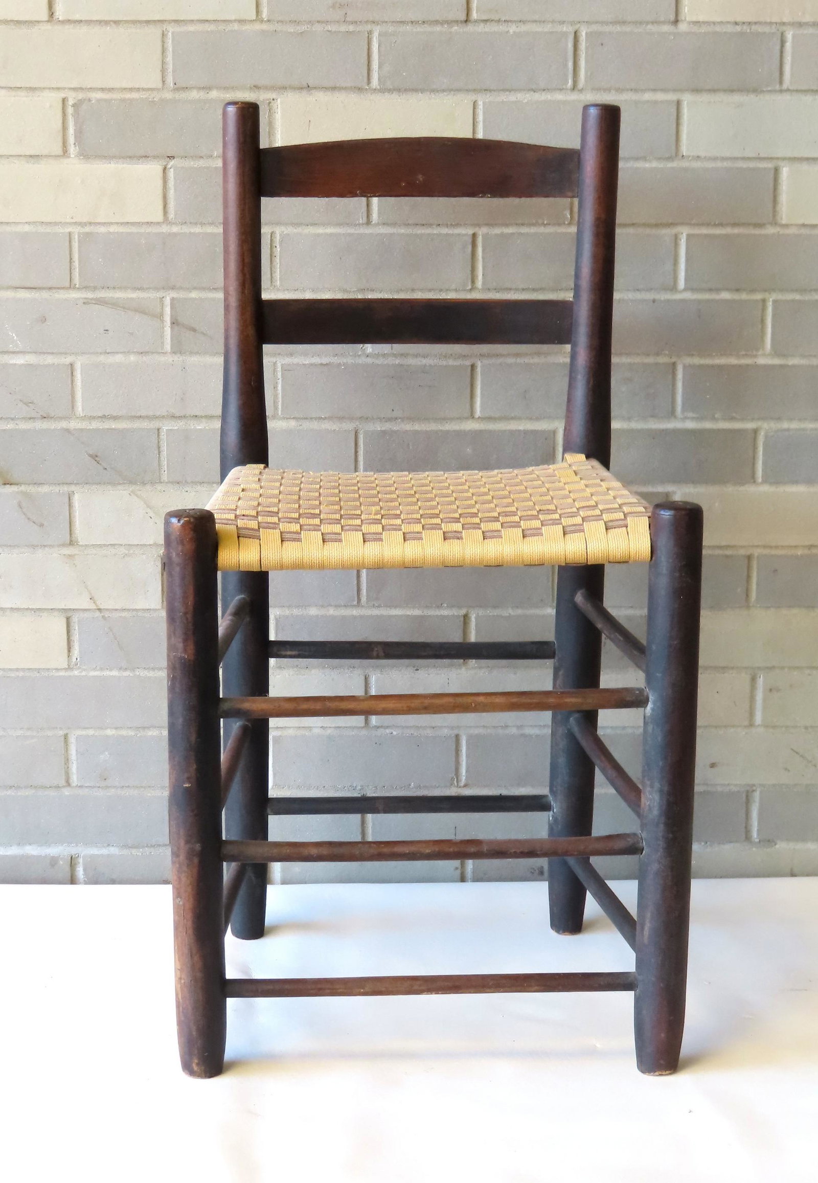 A Shaker low-back or weaver's chair, 19th century with a woven cloth seat. Good condition. Measures: A Shaker low-back or weaver's chair, 19th century with a woven cloth seat. Good condition. Measures 17 1/2"W x 14 1/4"D x 32 3/4" x 18 3/4" seat height. Provenance: From the estate of Barbara Becker, 