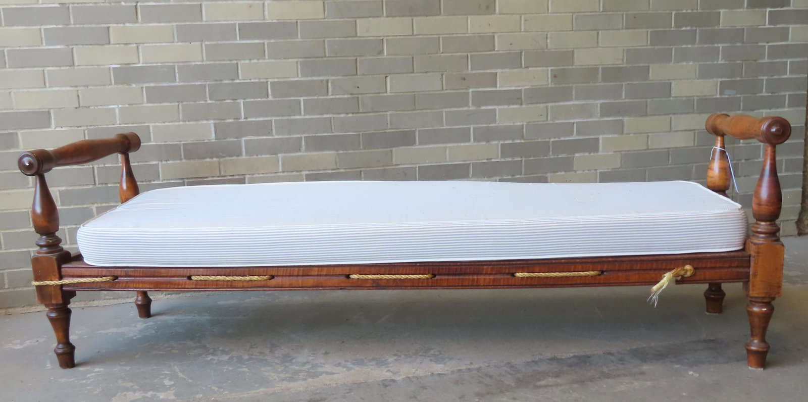 A tiger maple rope day bed, newer mattress: A tiger maple rope day bed, newer mattress - one of the 2 side rails is split in the middle and should be braced (currently held together by the ropes), otherwise good condition. Measures 75 1/4"L x 2