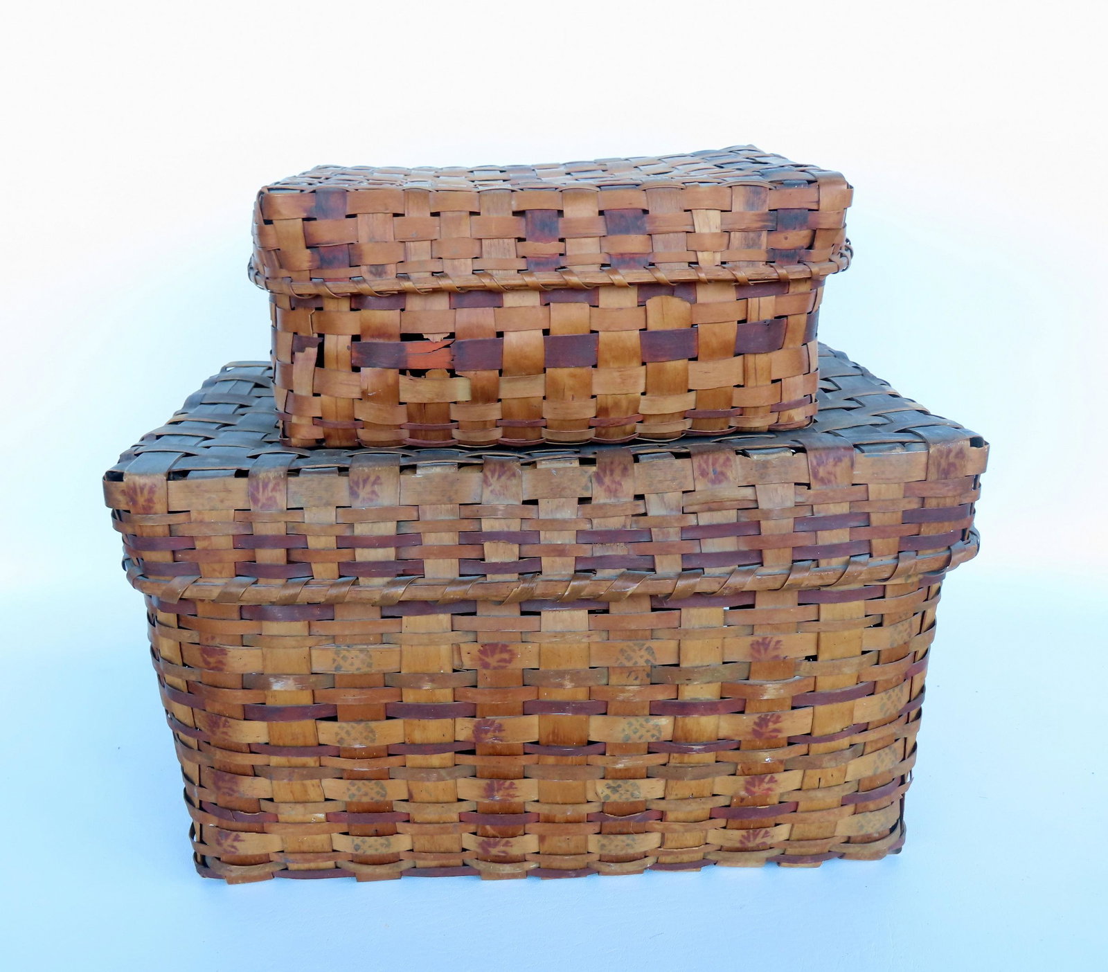 Two Native American lidded splint baskets. The smaller, with colored splints signed in ink by owner: Two Native American lidded splint baskets. The smaller, with colored splints signed in ink by owner "Jerusha Linsley born 1756" (Jerusha was born in Branford, New Haven CT), on underside of lid - 1 sp