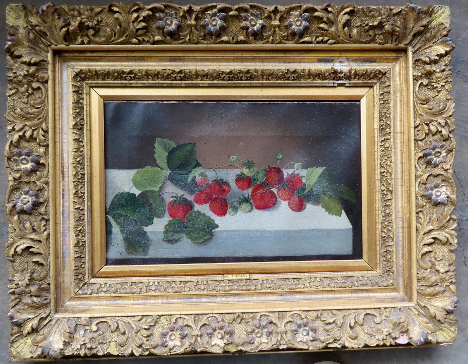 O/C Still life of strawberries on table in a 19th century gilt gesso frame that is not original as: O/C Still life of strawberries on table in a 19th century gilt gesso frame that is not original as name plate on frame is marked J.H. Dolf and the painting is initialed in lower left corner J.E.W. 187