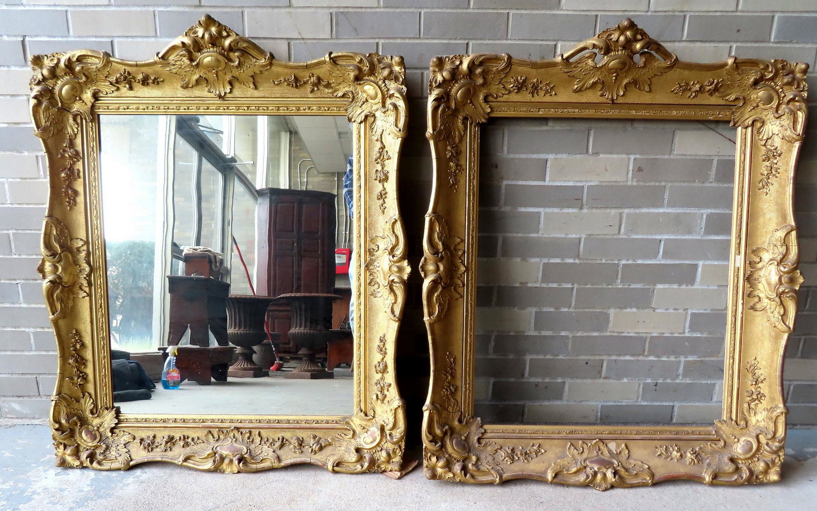 Two ornate gilt gesso matching portrait frames with elaborate decorations of eagle wings, scrolls: Two ornate gilt gesso matching portrait frames with elaborate decorations of eagle wings, scrolls and leaves, mid 19th century. One frame currently used as a large wall mirror. Total frame size of eac