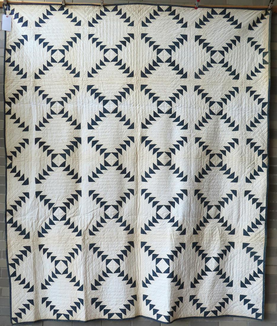 A blue and white patchwork quilt in flying geese pattern, late 19th century, signed in ink: A blue and white patchwork quilt in flying geese pattern, late 19th century, signed in ink "Elizabeth Spraker" (quilt came from a Westchester County collection but unsure of original origin). 90" x 79
