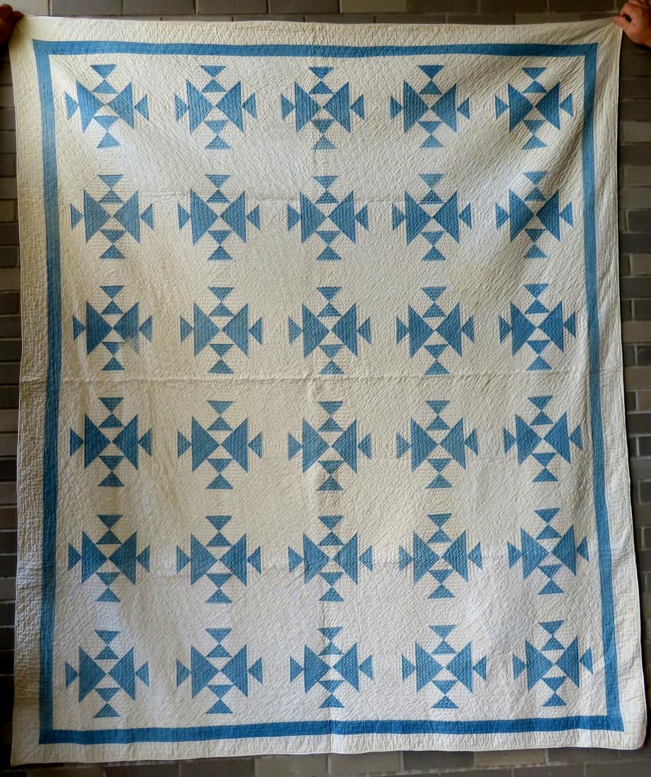 A light blue and white patchwork quilt, hand sewn with matching rectangular border, late 19th: A light blue and white patchwork quilt, hand sewn with matching rectangular border, late 19th century - very dense quilting, 72" x 85". A newer rolled edging, very light soiling on reverse side, other