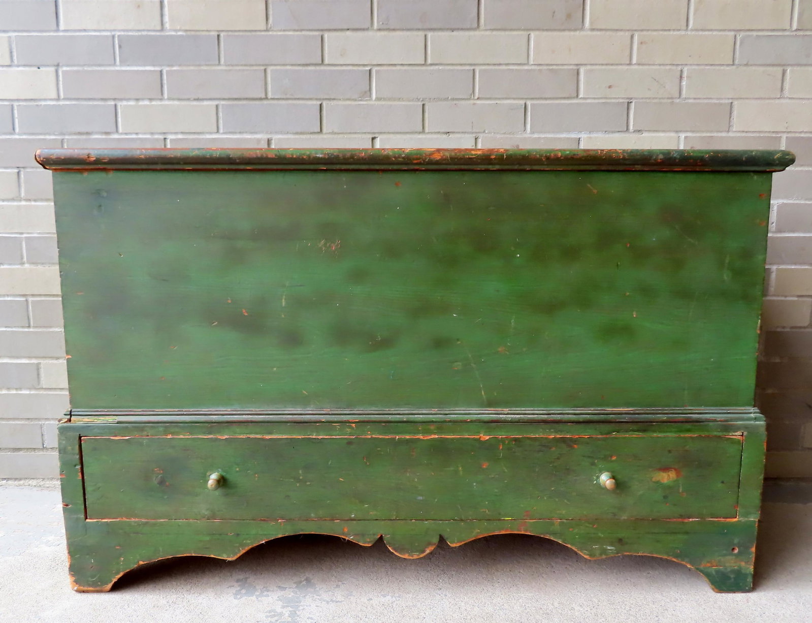 A good blanket chest mounted on a high cutout base and having 1 lower drawer, dovetailed case, in: A good blanket chest mounted on a high cutout base and having 1 lower drawer, dovetailed case, in original green paint. Some repairs to original feet, the back edge of lid with professional repair har