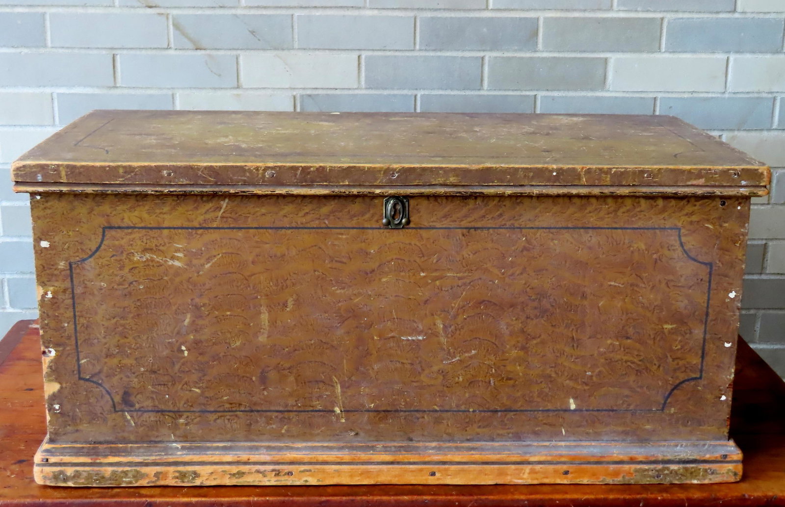 A small grain painted blanket box with interior till, original molding around base, mid 19th: A small grain painted blanket box with interior till, original molding around base, mid 19th century. Minor use wear on lid and overall good condition. Measures 33 1/4"W x 16 3/4"D x 15 1/4"H. Provena