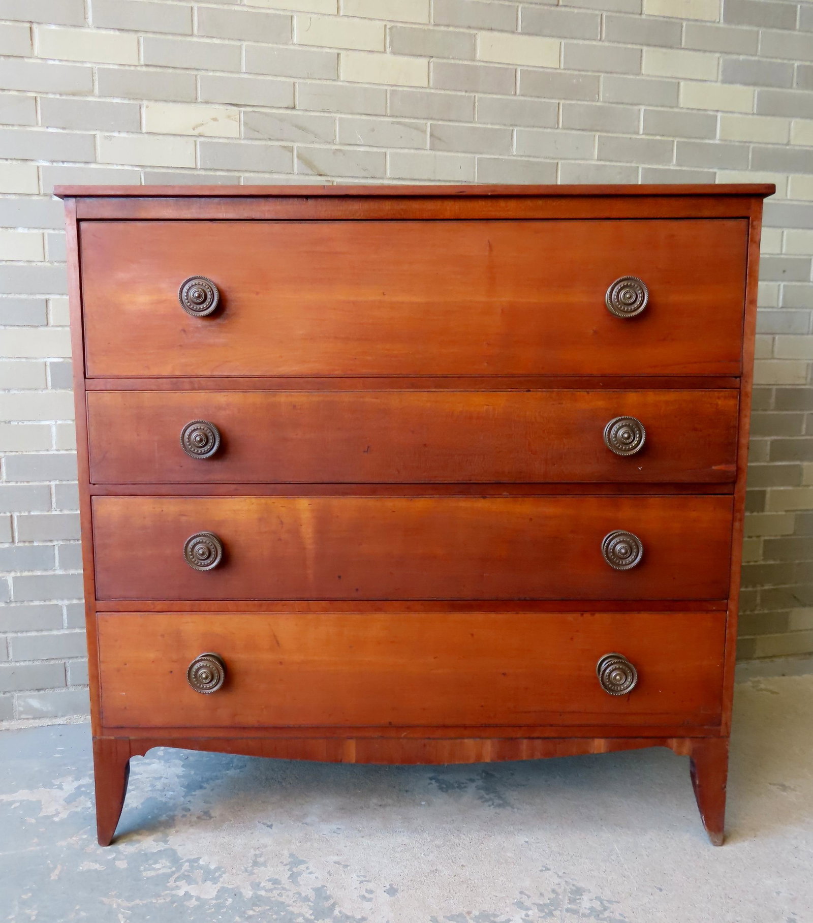 A cherry Hepplewhite chest having one deep drawer over 3 graduated drawers, original brass pulls,: A cherry Hepplewhite chest having one deep drawer over 3 graduated drawers, original brass pulls, French feet - very good condition, early 19th century. Measures 43"W x 19 1/4"D x 42 1/2"H.
