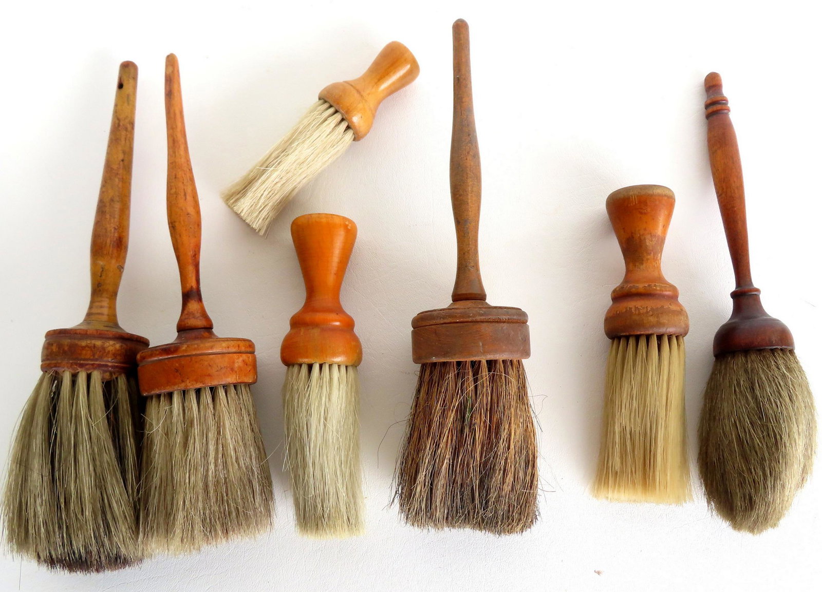 A grouping of seven 19th century brushes, most with original horse hair and turned wood handles. The: A grouping of seven 19th century brushes, most with original horse hair and turned wood handles. The largest 11 1/2"L. Provenance: From the estate of Barbara Becker, High Falls NY. This lot is part of