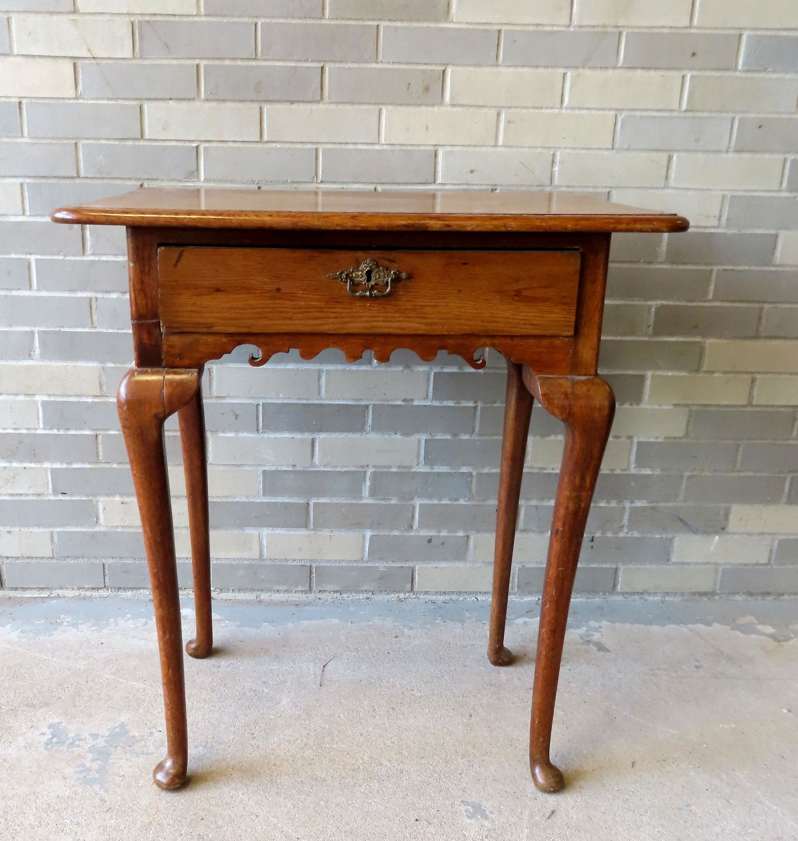 A Queen Ann style work table with drawer with molded edge, scrolled apron on front and sides, and: A Queen Ann style work table with drawer with molded edge, scrolled apron on front and sides, and having cabriole legs leading to pad feet, probably mid 19th century. Very good condition. 29 1/4"W x 2