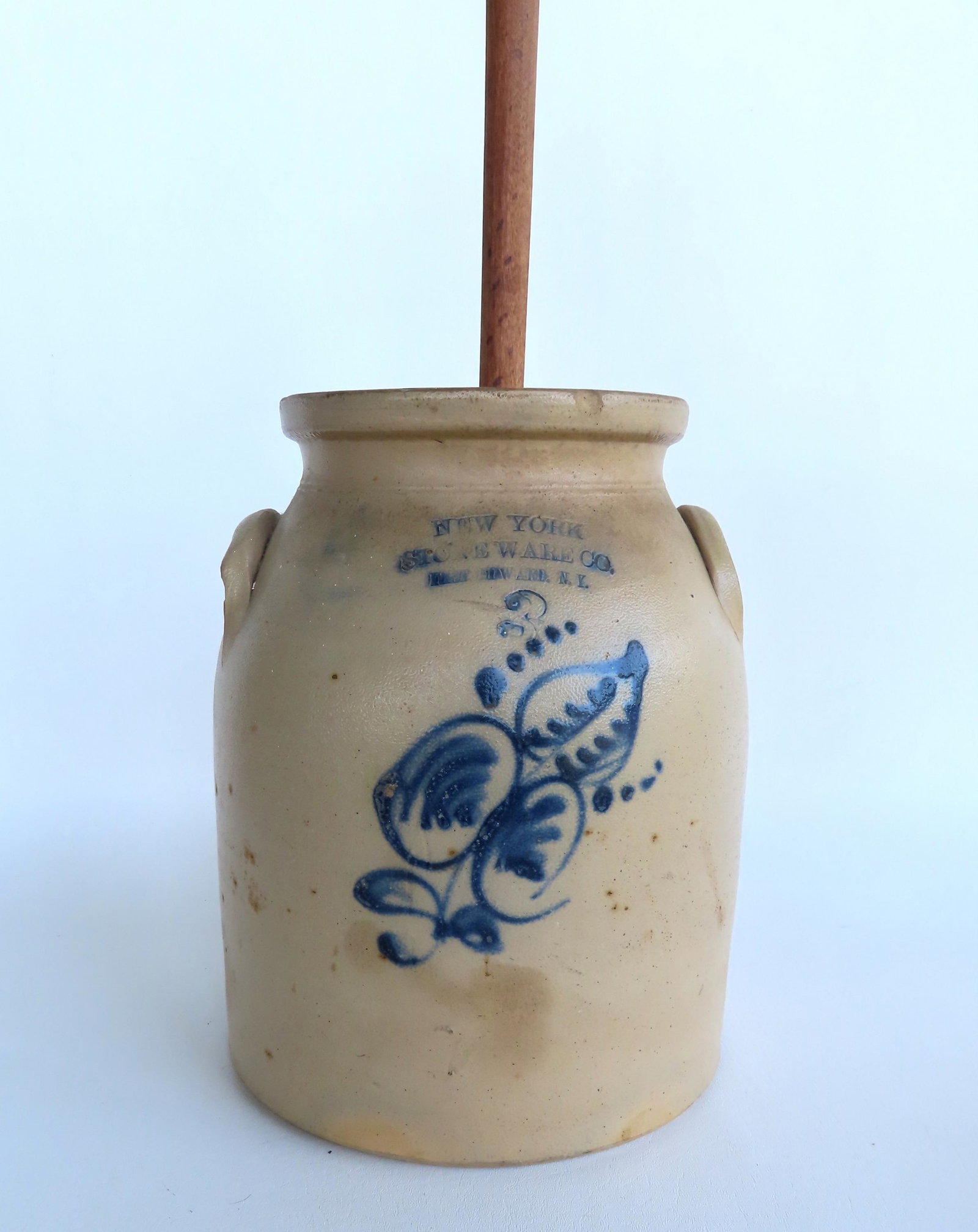 A stoneware butter churn crock with the impressed mark "New York Stoneware Co. Fort Edward N.Y.", 3: A stoneware butter churn crock with the impressed mark "New York Stoneware Co. Fort Edward N.Y.", 3 gallon. Small edge chip, light staining, tiny flakes on one ear and very tight hairline adjacent to 