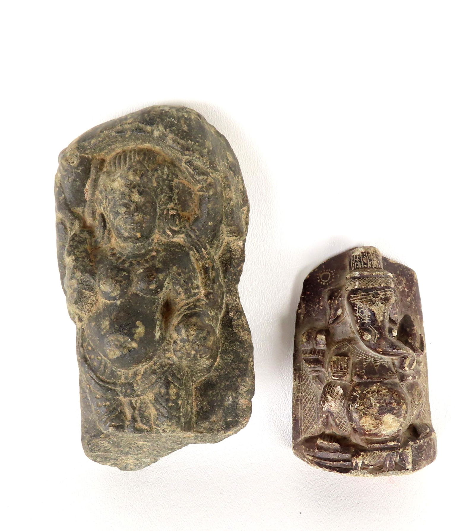 Two old stone sculptures including: The first, of a nude female figure, probably in granite, losses: Two old stone sculptures including: The first, of a nude female figure, probably in granite, losses to lower section -unsure of age but likely centuries old - 6 1/4"H x 2 3/4"W; and a soapstone carved