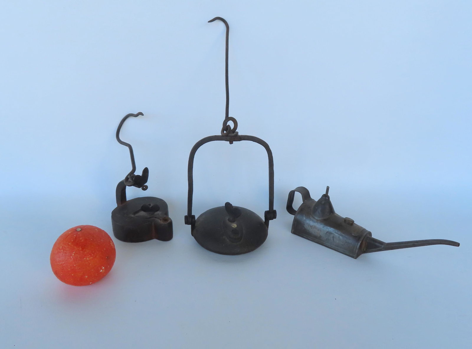 Grouping of 3 early tin and iron lighting related devices including: A Betty lamp with heart finial: Grouping of 3 early tin and iron lighting related devices including: A Betty lamp with heart finial and original hand forged iron hanging hook - very good condition - late 18th century - 9 1/2"H (top 