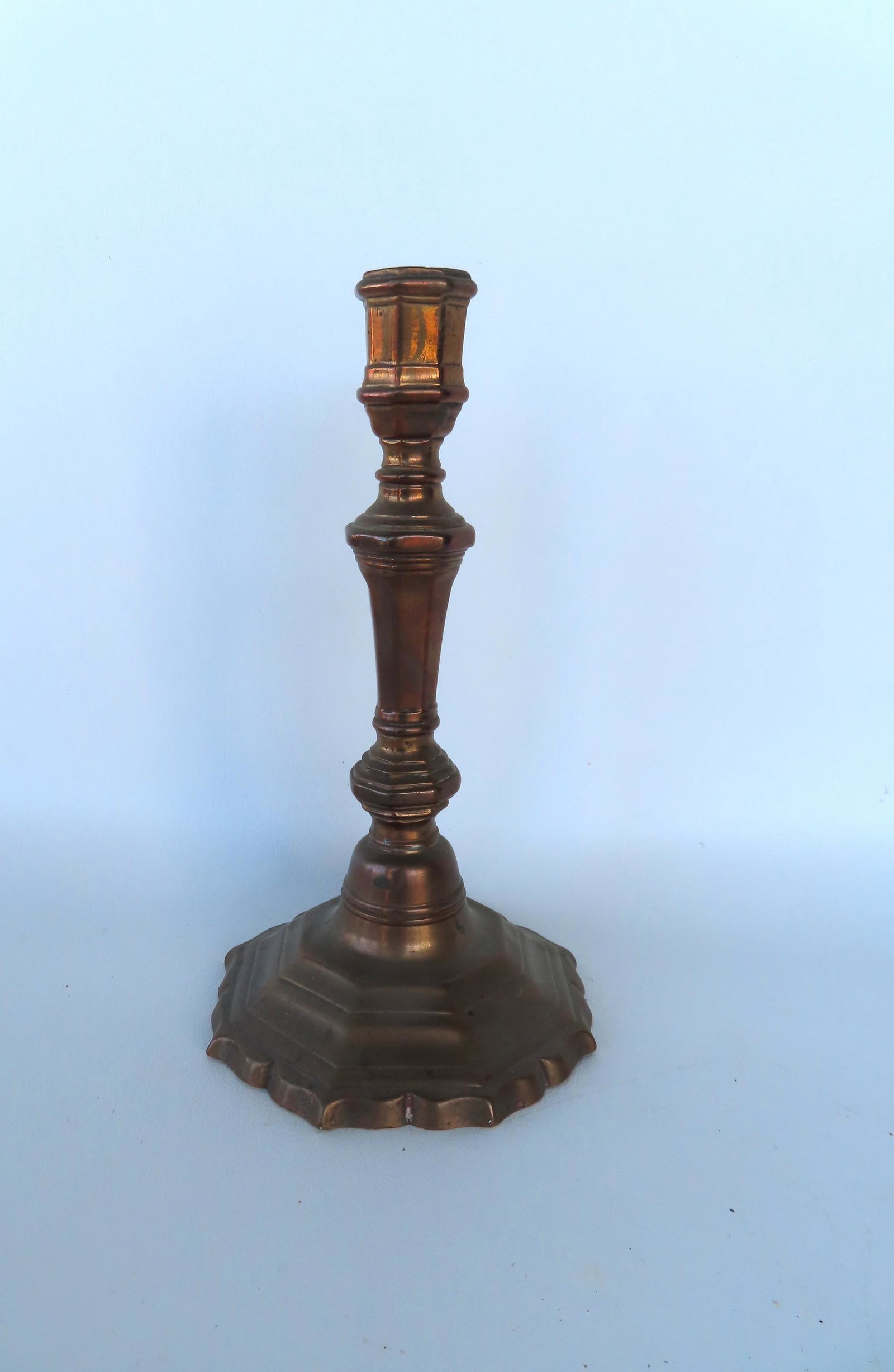 An 18th century brass candlestick with a shaped and stepped base, good condition, probably Dutch.: An 18th century brass candlestick with a shaped and stepped base, good condition, probably Dutch. Measures 8 1/2"H x 4 5/8"W. Provenance: From the Nancy & Elliot Steckel estate, formally of Sharon CT.