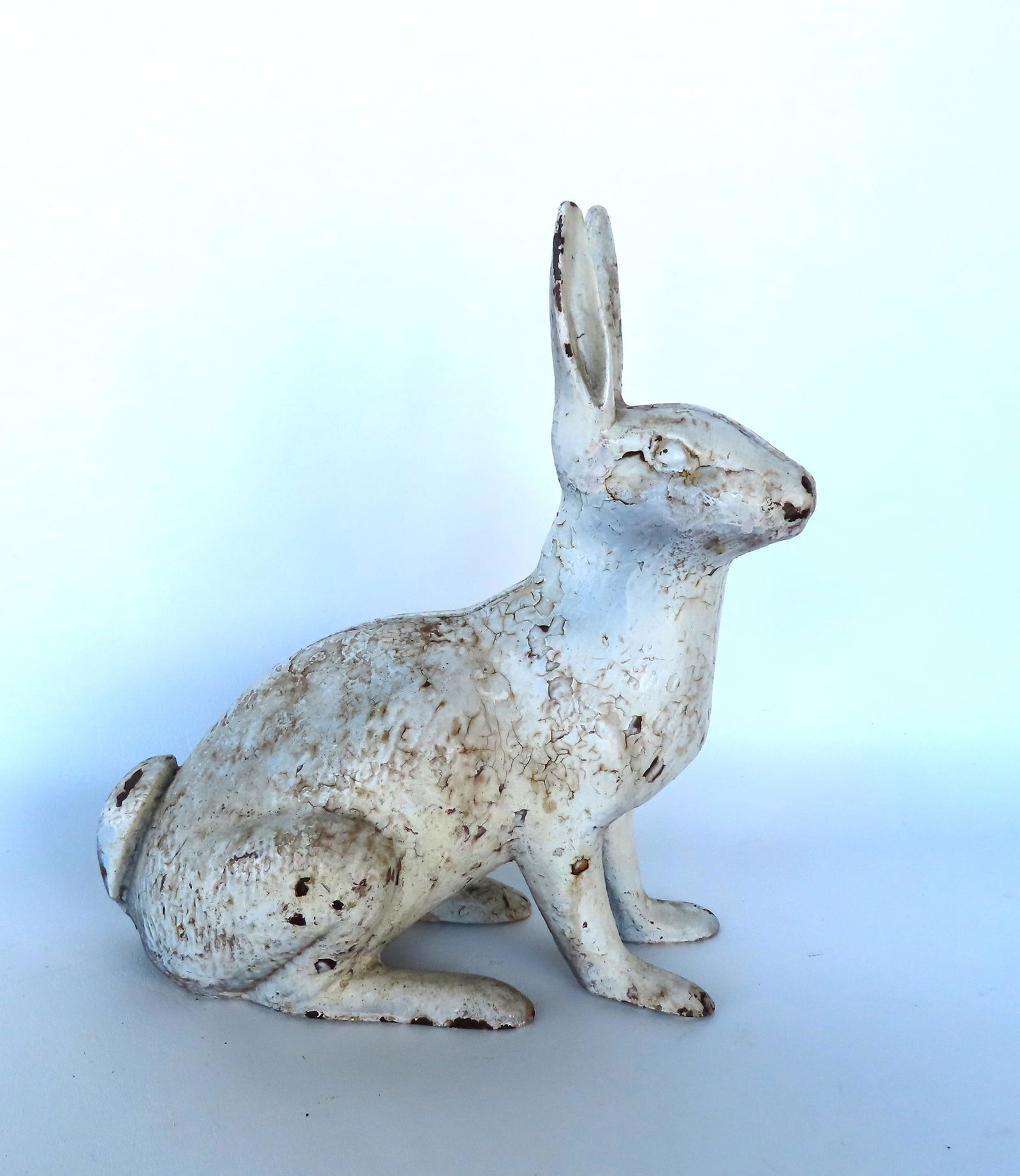 A cast iron rabbit door stop in layers of old white paint, late 19th century, very good condition.: A cast iron rabbit door stop in layers of old white paint, late 19th century, very good condition. Measures 11"L x 11 3/4"H.