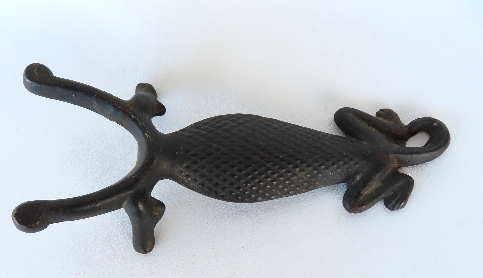 A cast iron boot jack in the form of a lizard, early 20th century, very good condition. Measures 10: A cast iron boot jack in the form of a lizard, early 20th century, very good condition. Measures 10 1/2"L x 3 7/8"W. Provenance: From the Nancy & Elliot Steckel estate, formally of Sharon CT.
