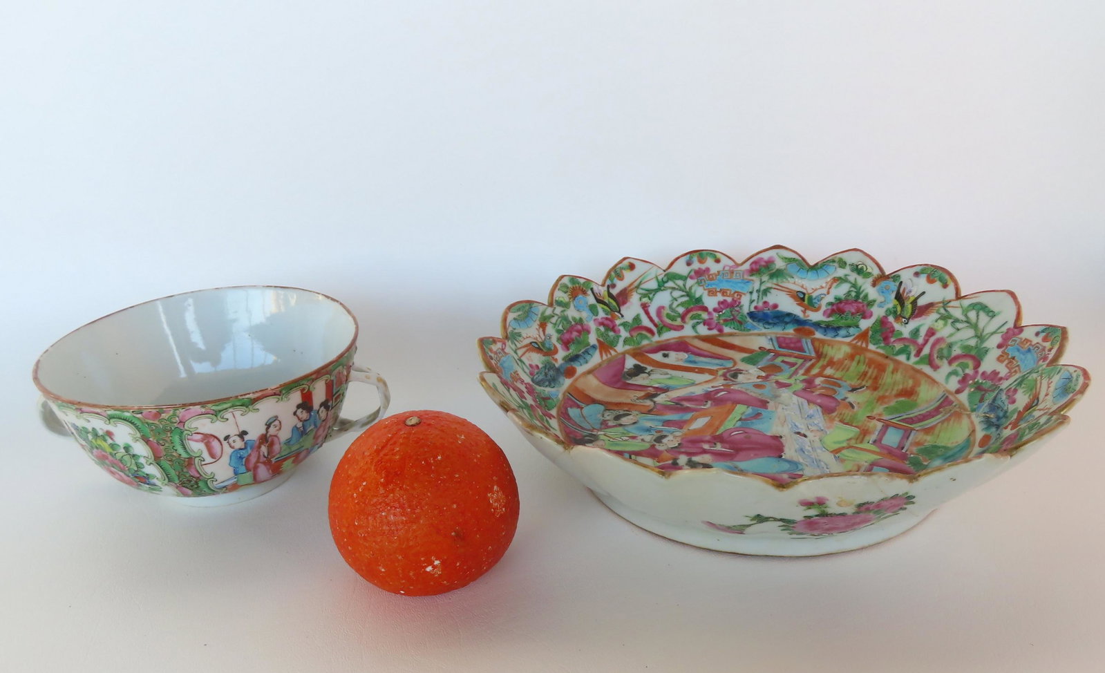 Two pieces of Rose Medallion pattern porcelains. The first, a small double handle bowl - very good: Two pieces of Rose Medallion pattern porcelains. The first, a small double handle bowl - very good condition, no damage - 7"W x 2 7/8"H; the second, a bowl with scalloped edge, central medallion of fa