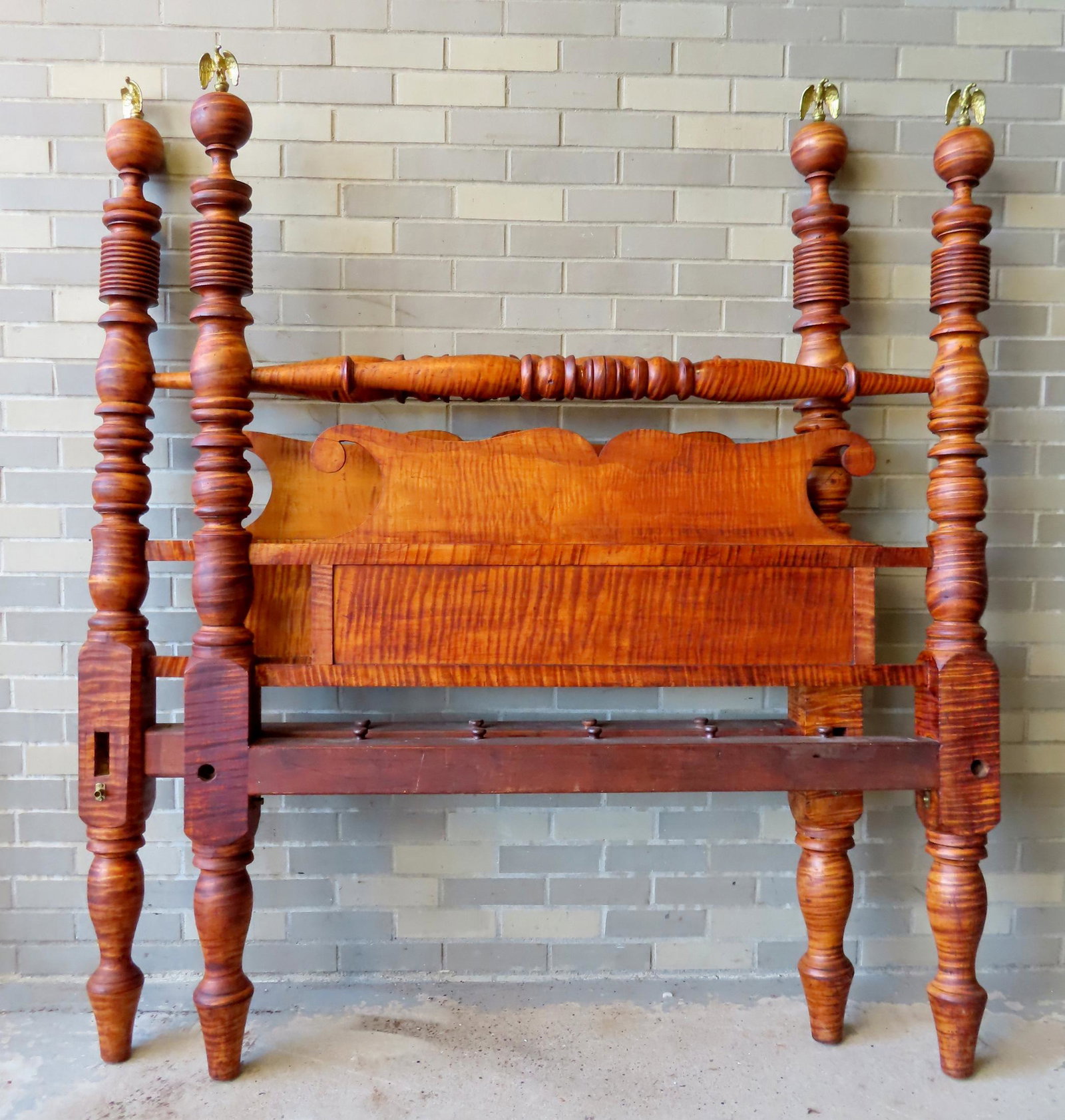 The best country tiger maple poster bed with strong graining throughout, mid 19th century. Includes: The best country tiger maple poster bed with strong graining throughout, mid 19th century. Includes brass spread wing eagle finials on all 4 posts. The side rails are likely replacements, and missing 
